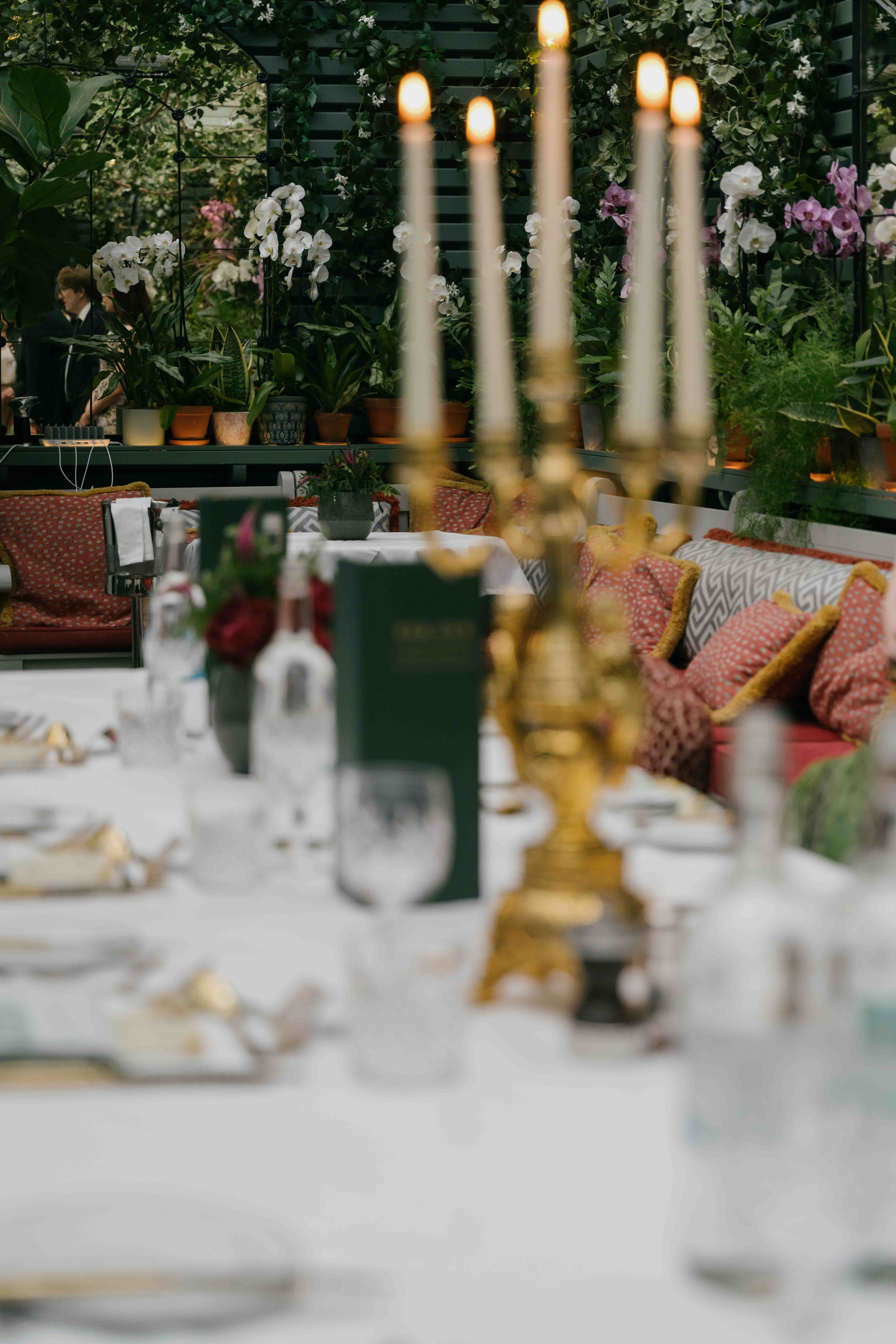 Wedding table setup at The Ivy London with flowers and candles, elegant reception details