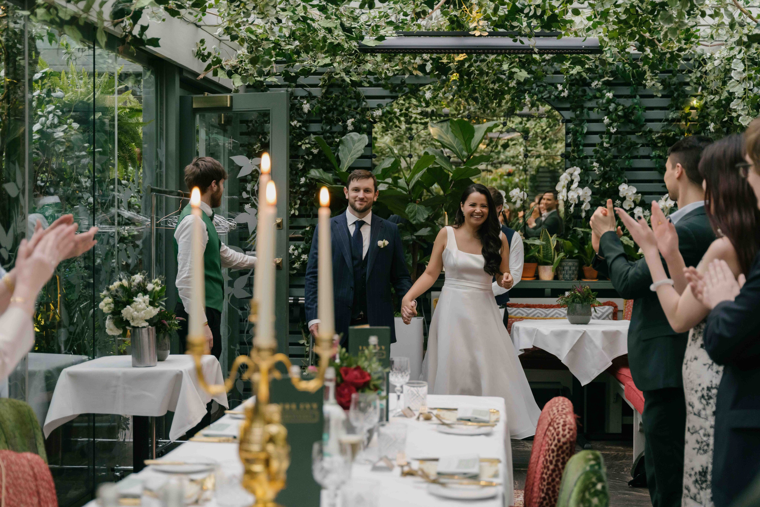 Bride and groom during wedding dinner at The Ivy, London intimate wedding reception