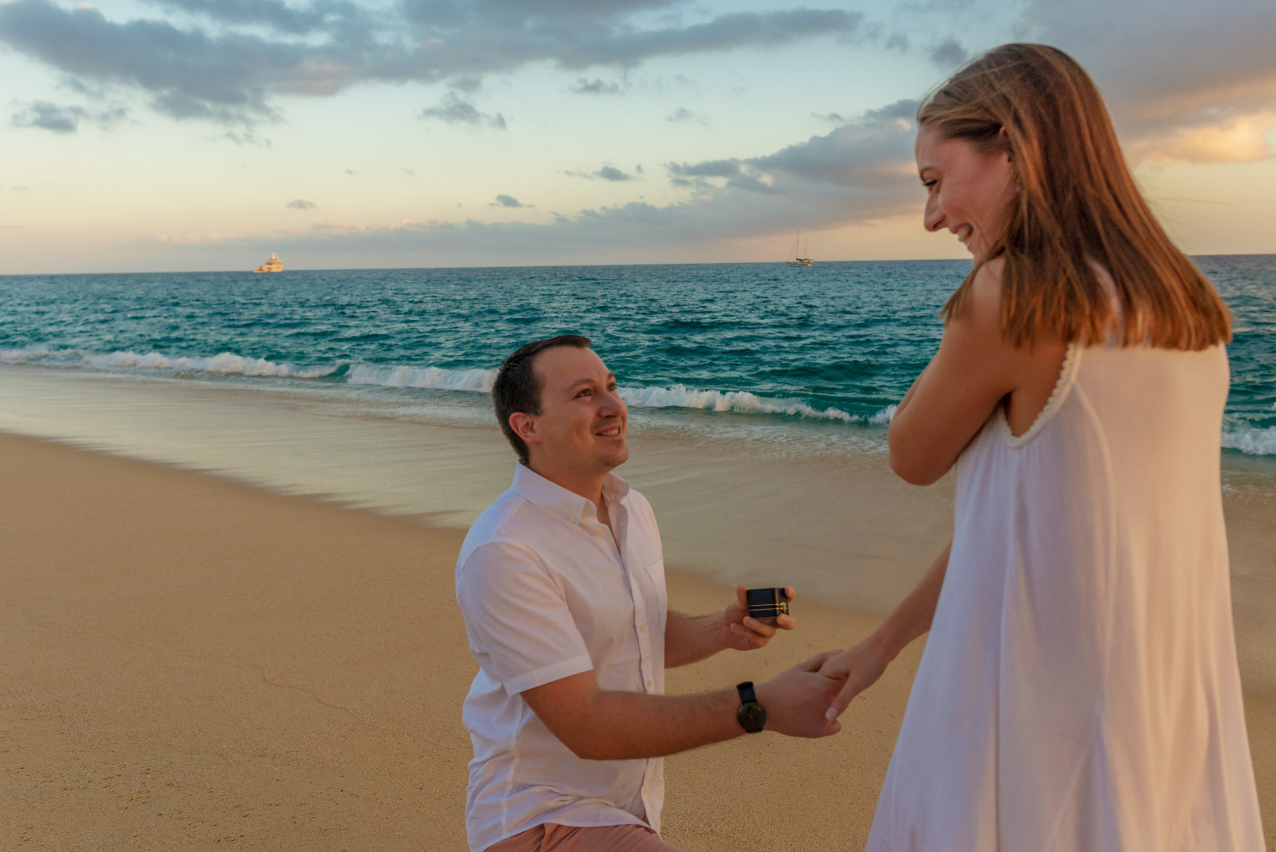 Man proposing to girlfriend during sunset photo session on beach in Los Cabos Mexico
