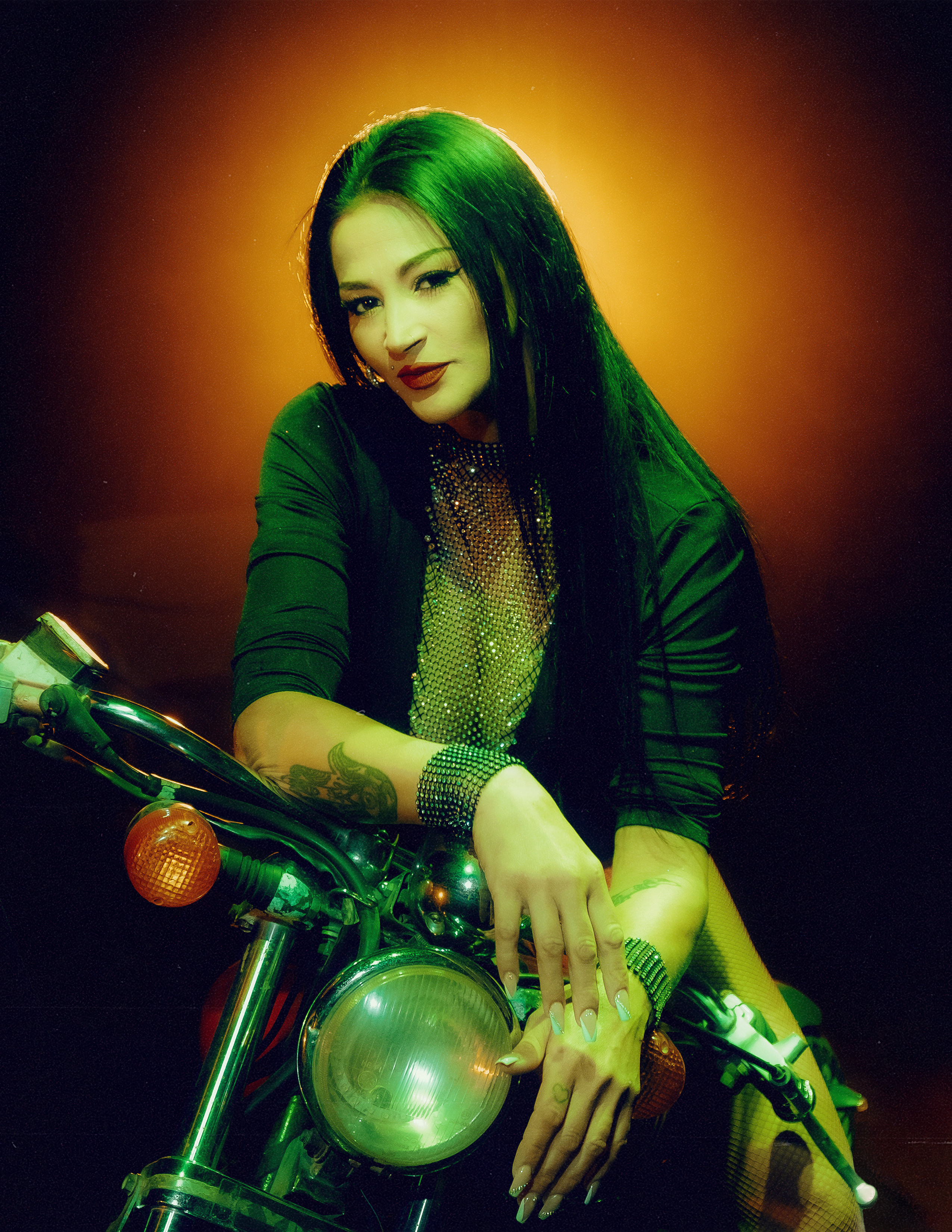 Glamorous photoshoot for a circus performer: motorcycle, fashion and dynamics