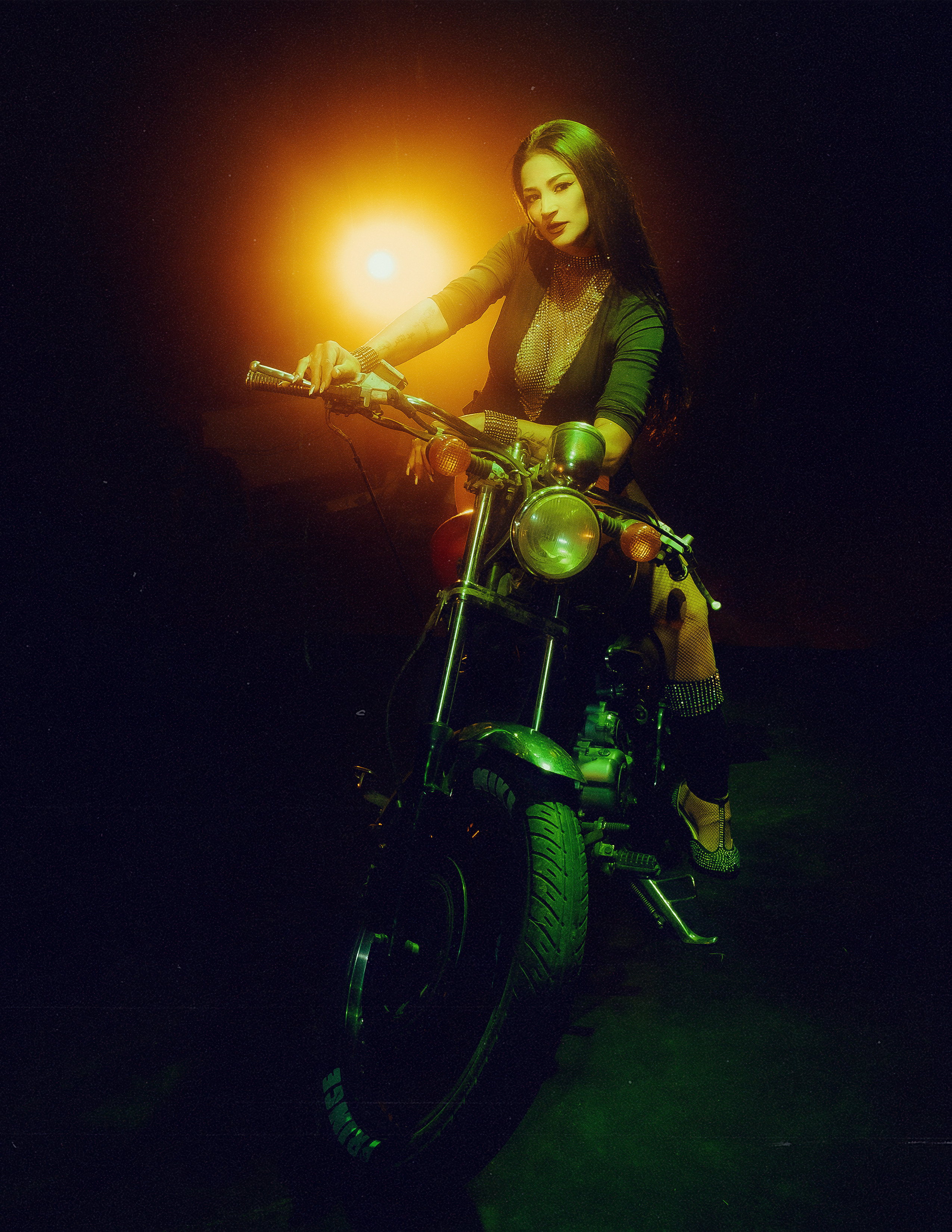 Glamorous photoshoot for a circus performer: motorcycle, fashion and dynamics