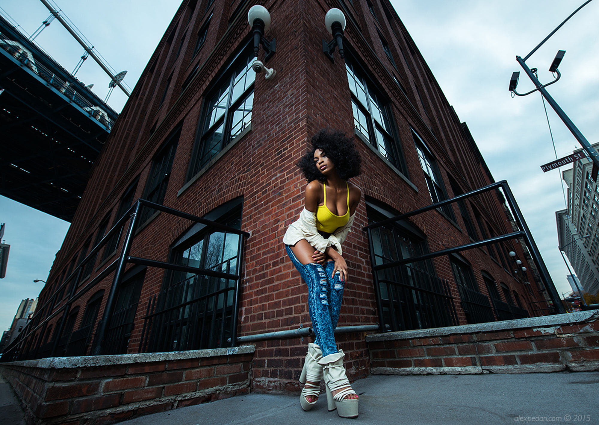 Ebony afro-american young hot girl in Dumbo, Brooklyn. Wide angle fashion editorial shot.