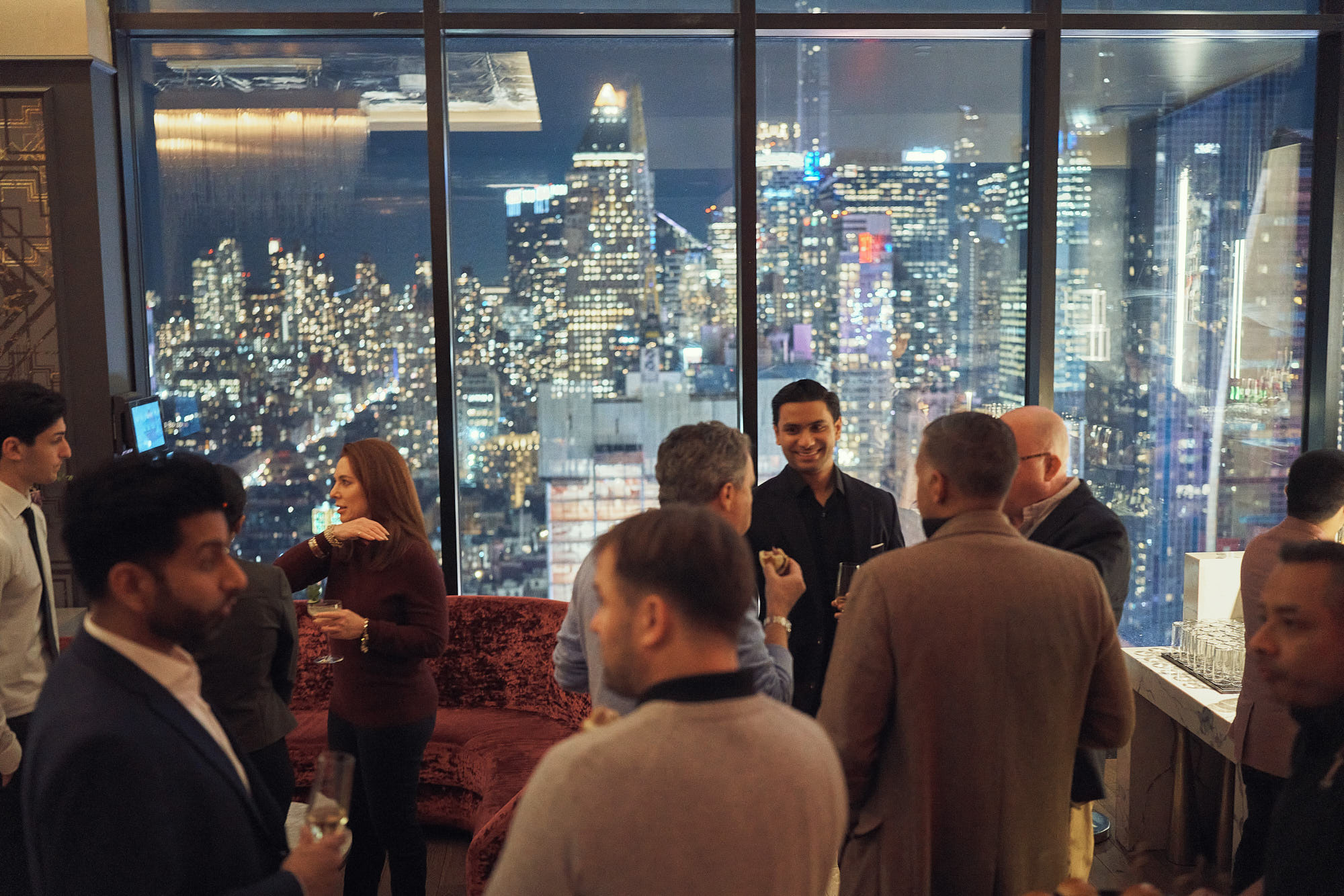 Corporate team building party on NYC rooftop, with stunning New York skyline in the background.