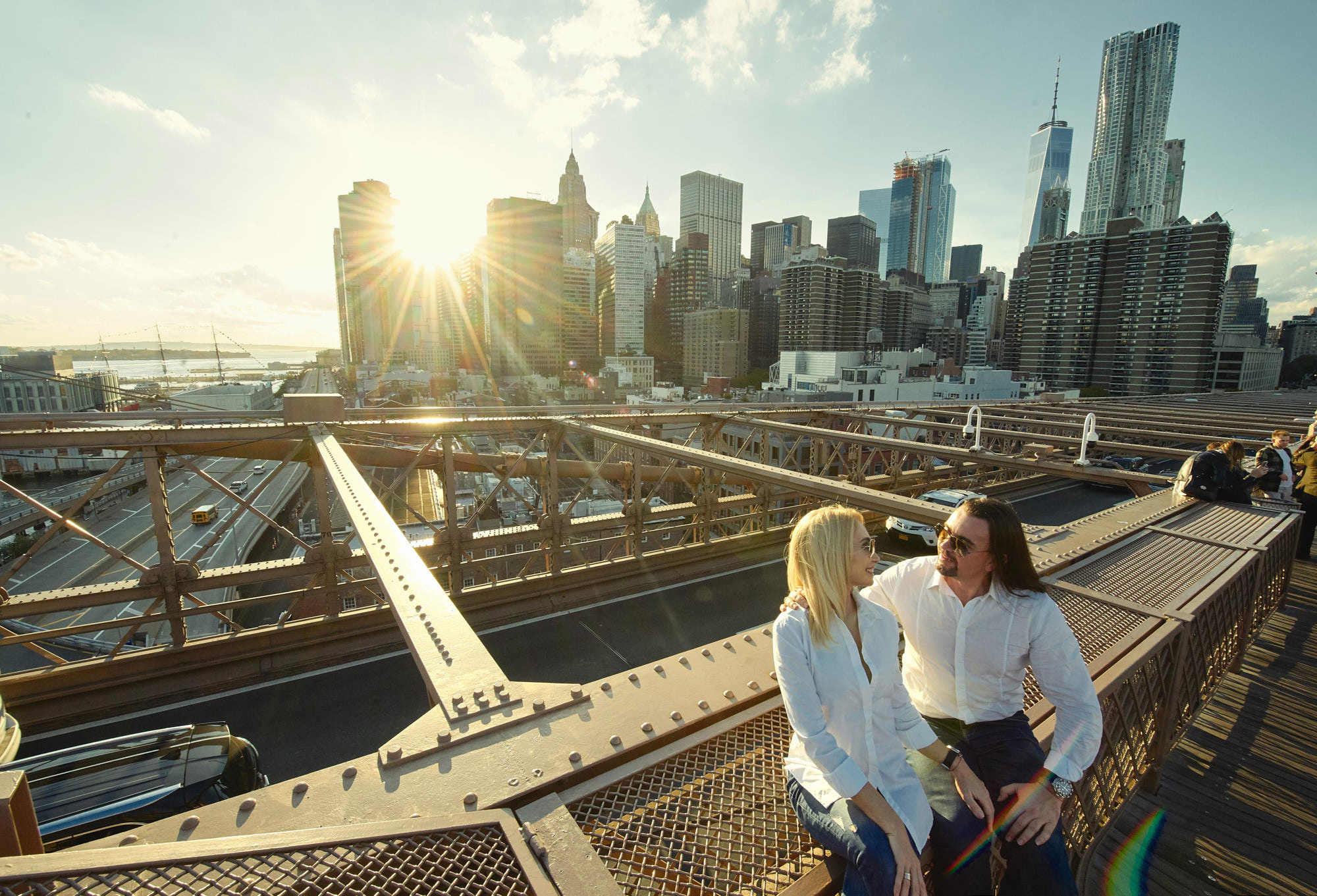 Surprise engagement idea of proposal on top of Brooklyn Bridge with Manhattan view on a sunset.