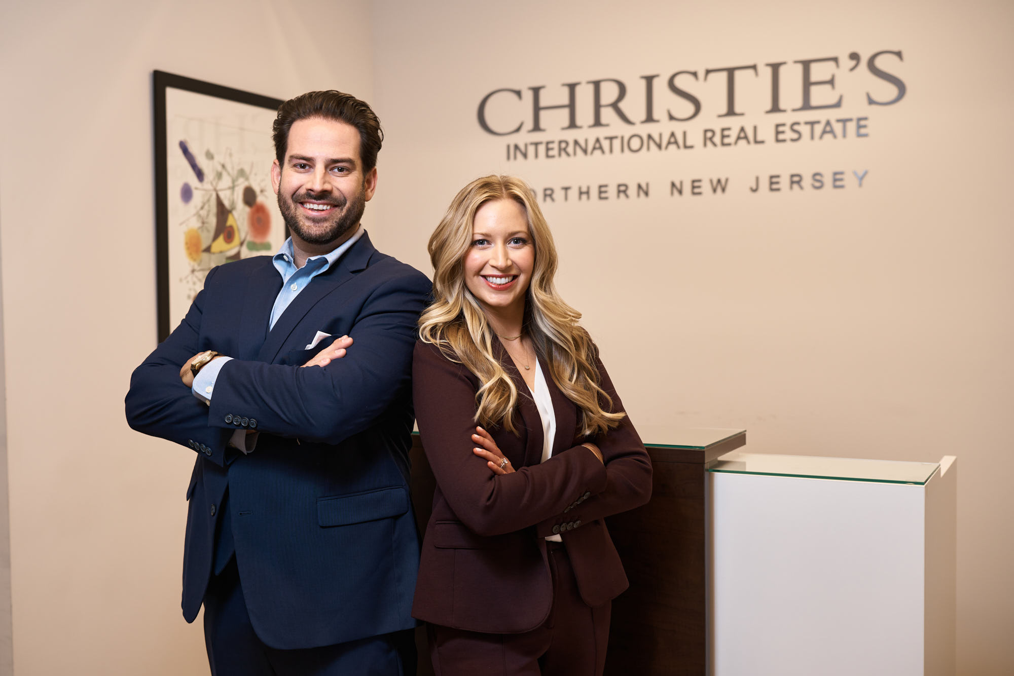 Corporate headshot of Curtis and Erica at their Montclair office of Christie’s International Real Estate Group NJ