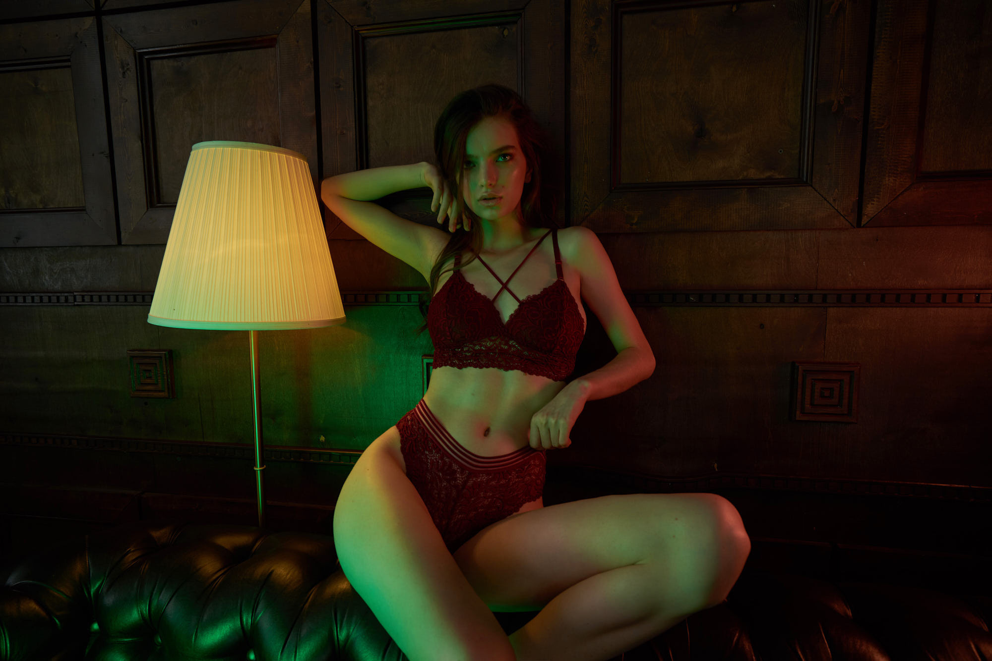 Racy photography of a top model Natalia wearing red lace underwear shot in mixed light, Roxy Hotel New York.