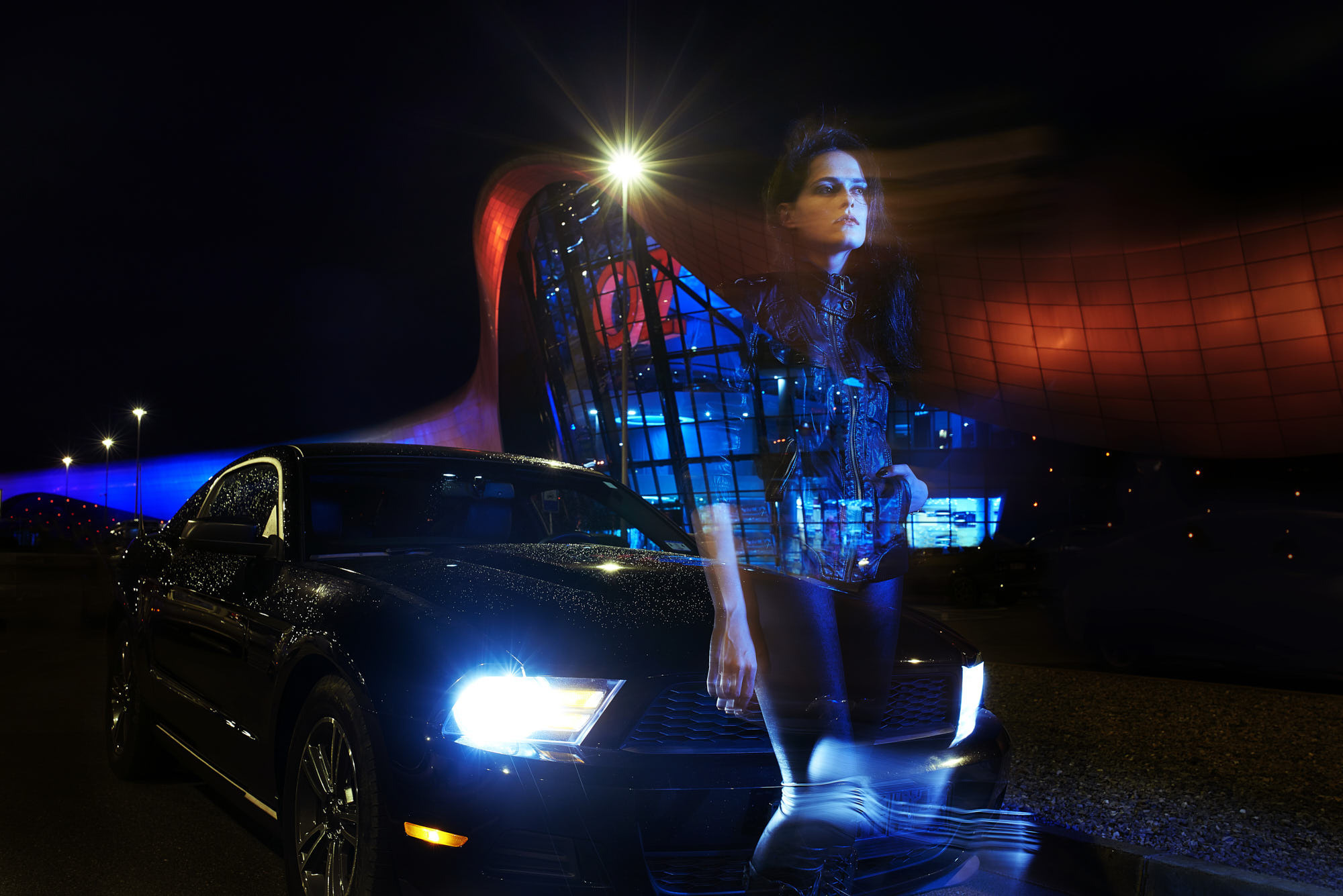 Muscle car editorial night shot after the rain with OZ mall sign at the background. Model looks like Kristen Stewart.