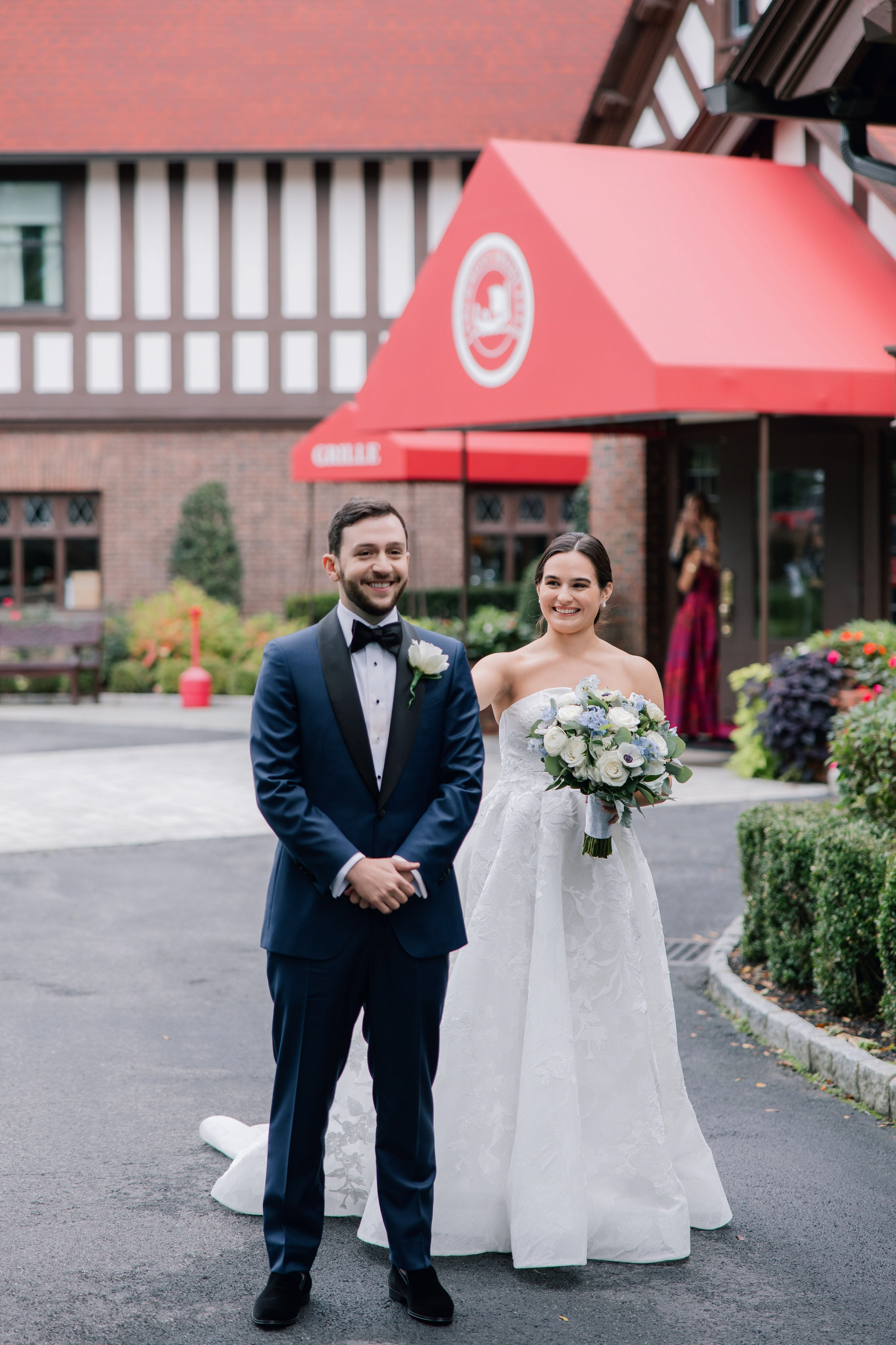a bride and groom walking down the street