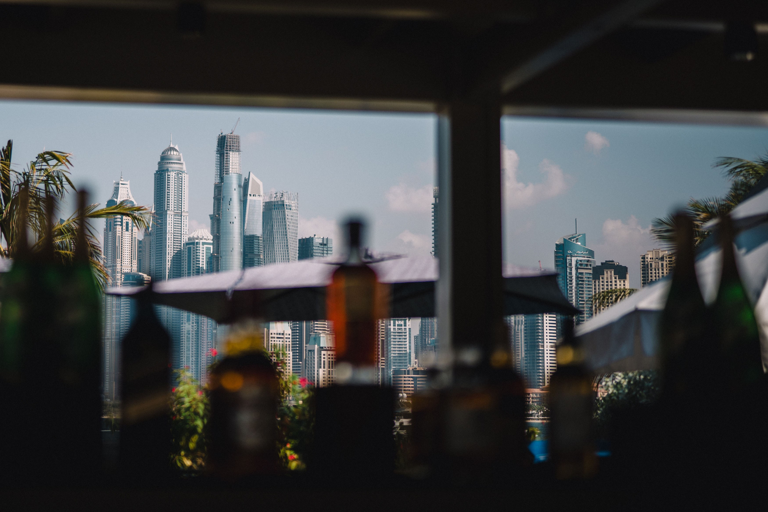 View with buildings on a background and the bar with beverages in a front view