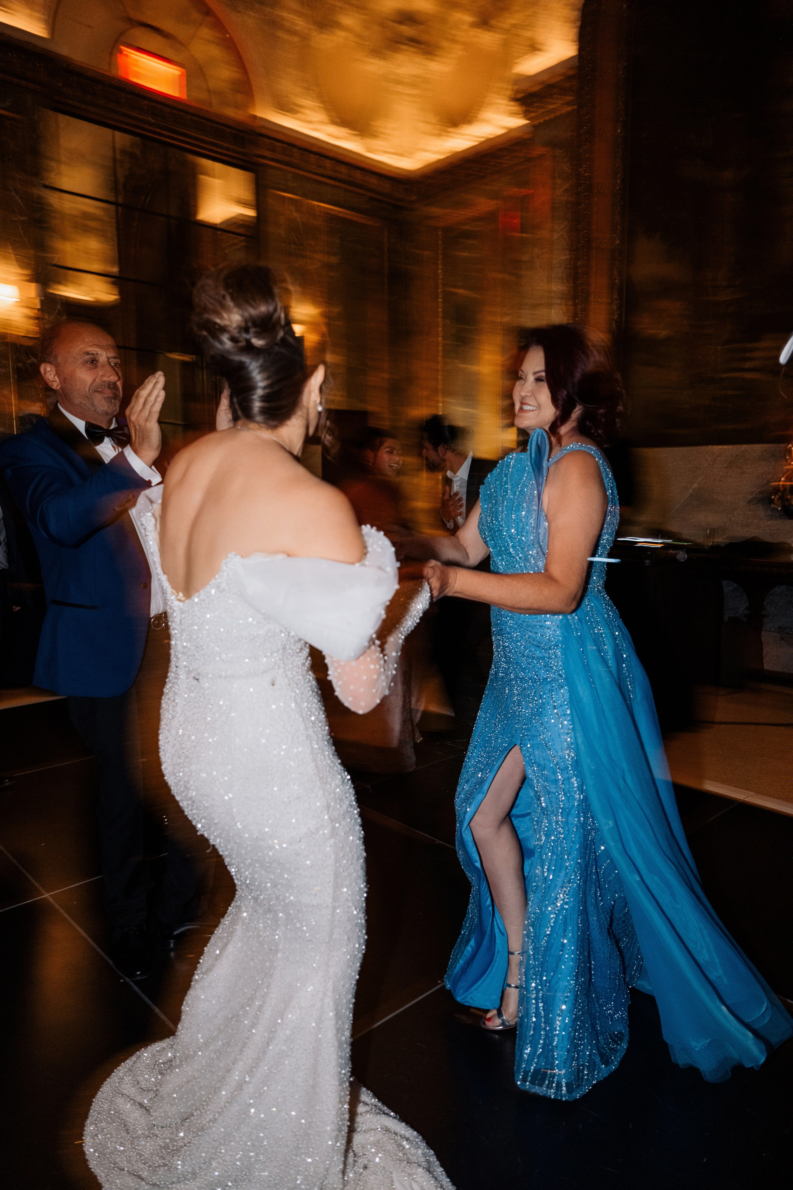 a woman in a blue dress dancing with a man in a suit