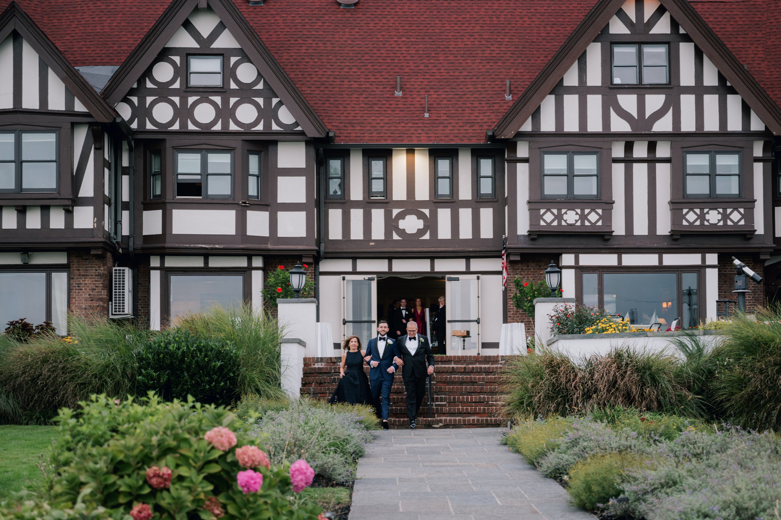 a couple standing in front of a house