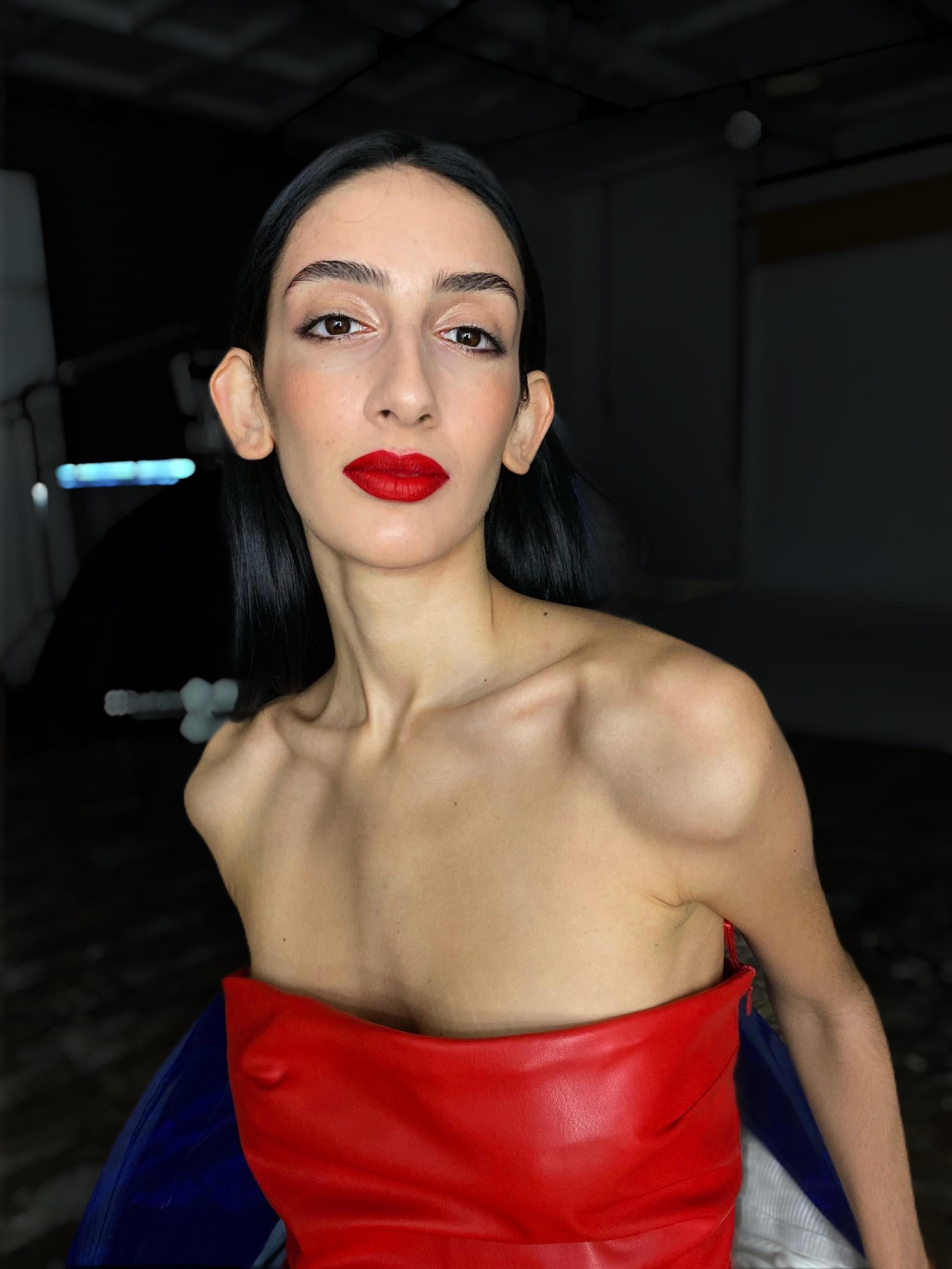 red lips makeup on a masculine model in a red dress