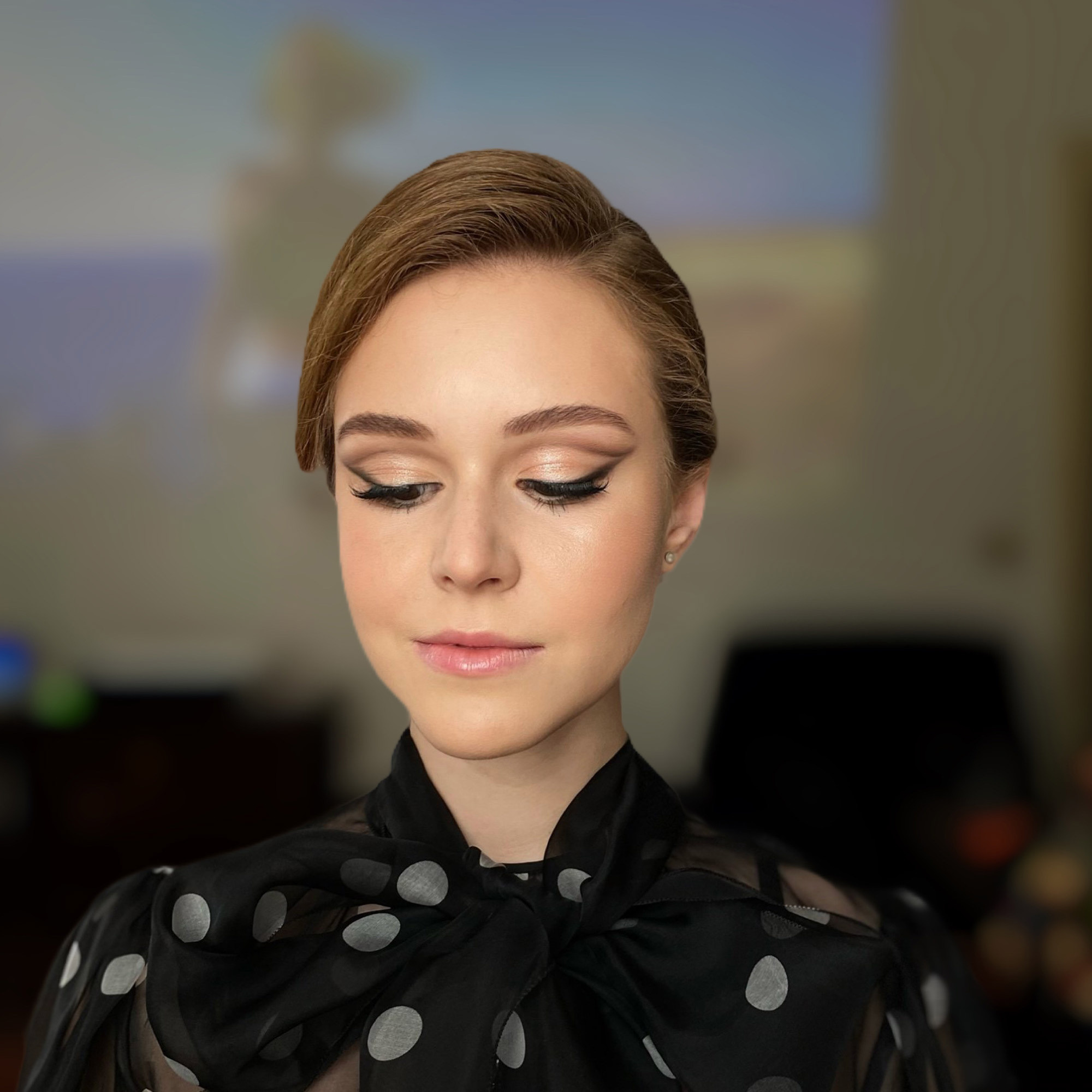 a white woman with soft face features with a pinup style makeup and elegant bun in dolce & gabbana dress