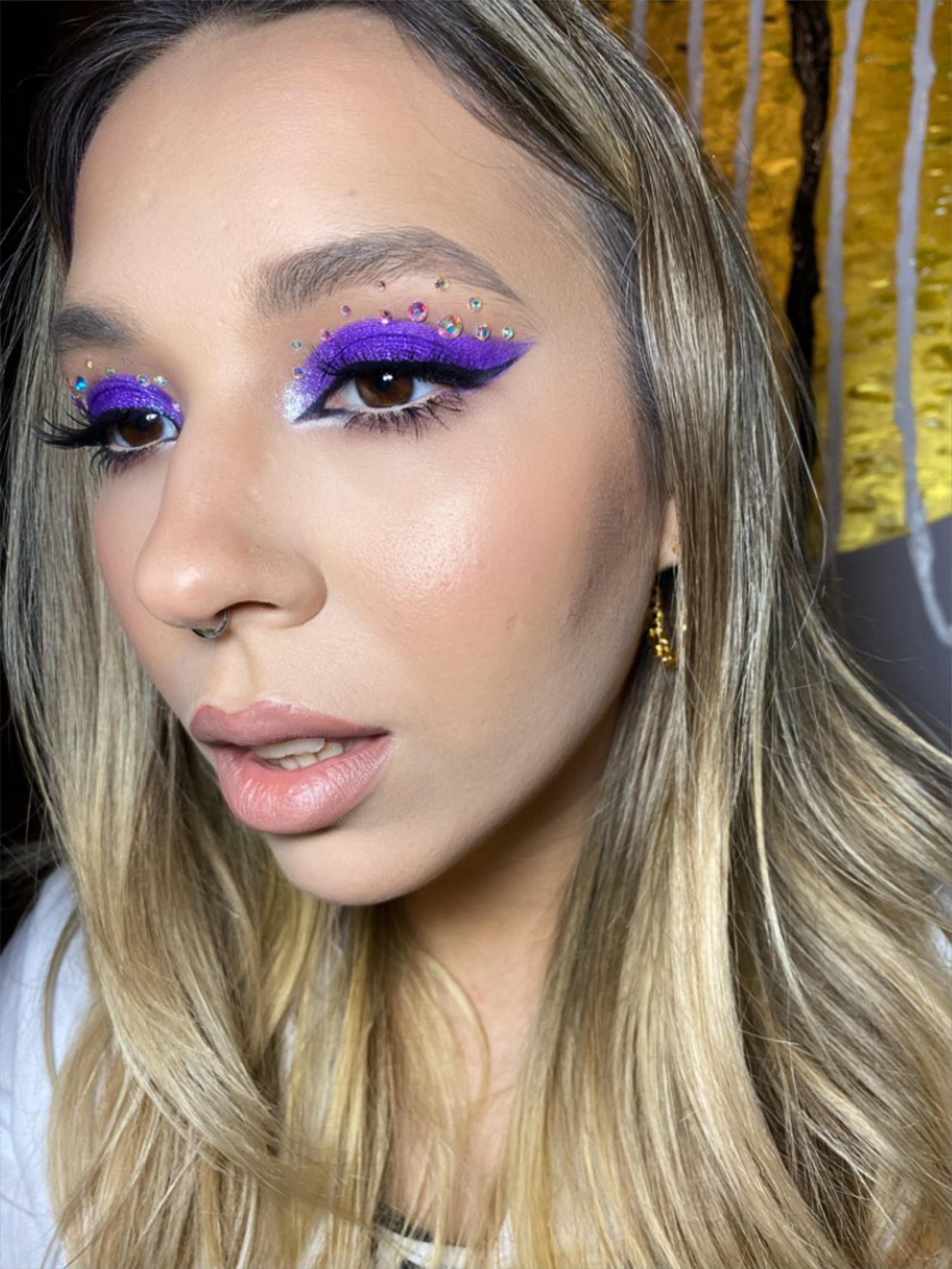purple makeup with shiny rhinestones on the eyes done in rome