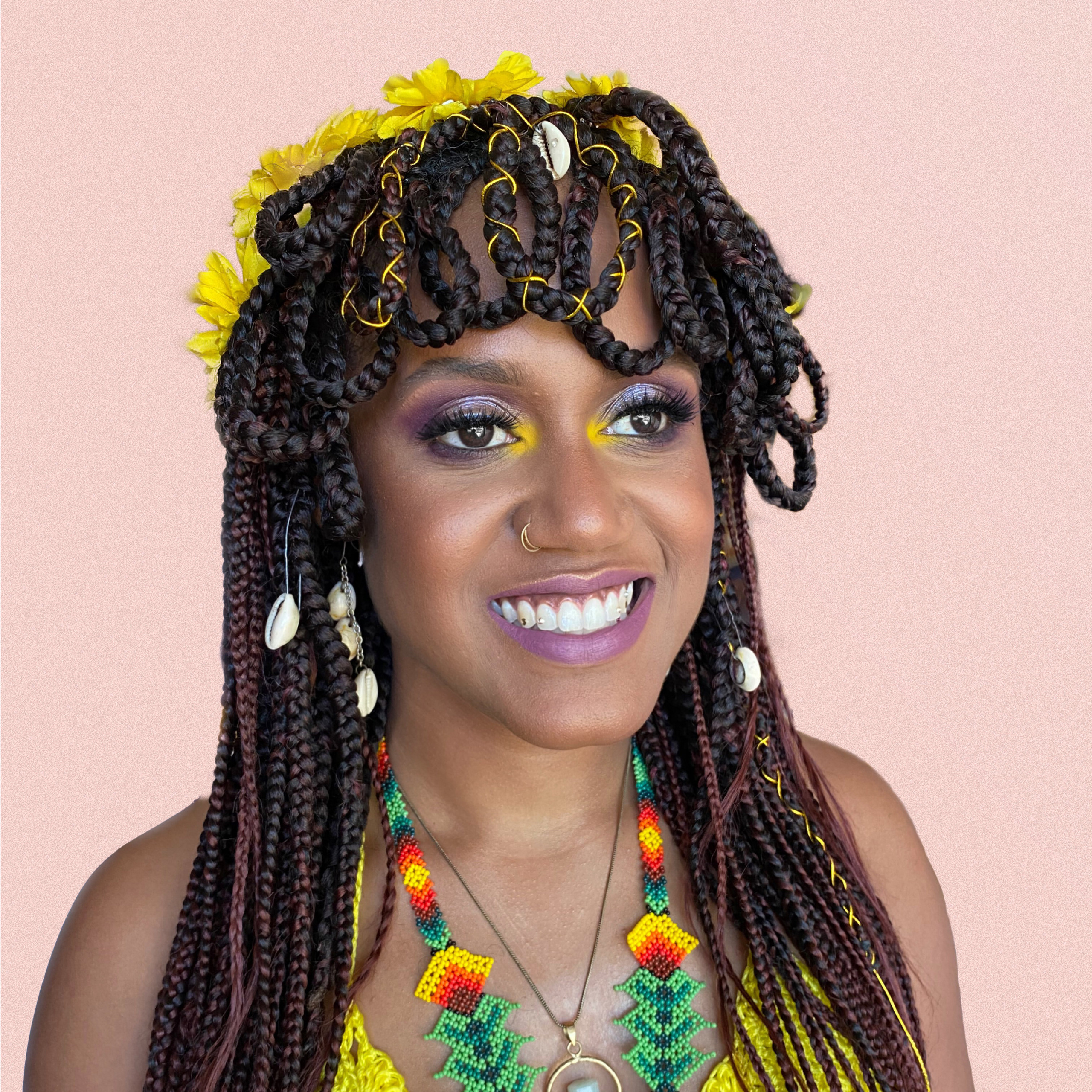 colorful makeup with yellow accent on a dark skin smiling woman