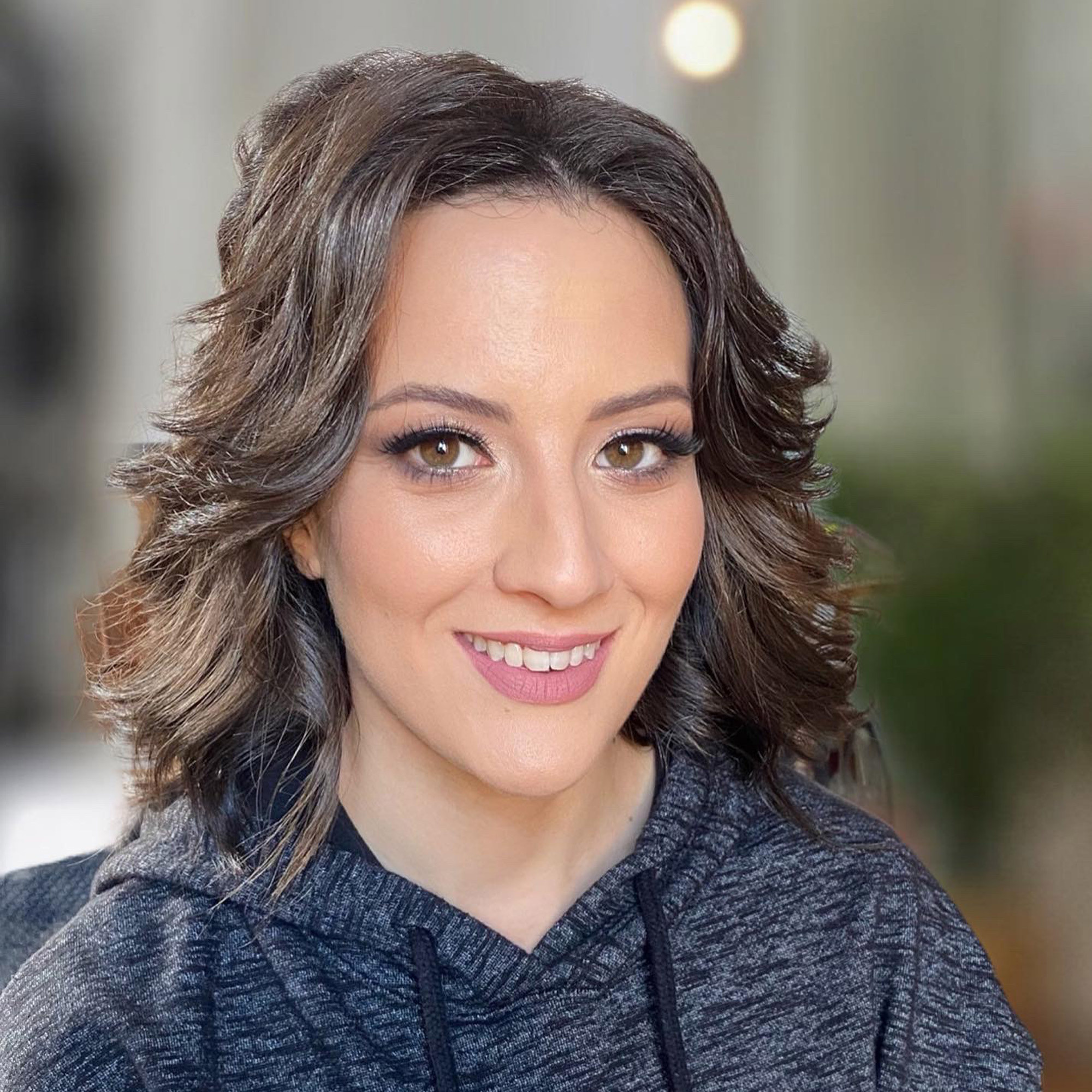 smiling italian woman with bridal makeup and wavy hairstyle