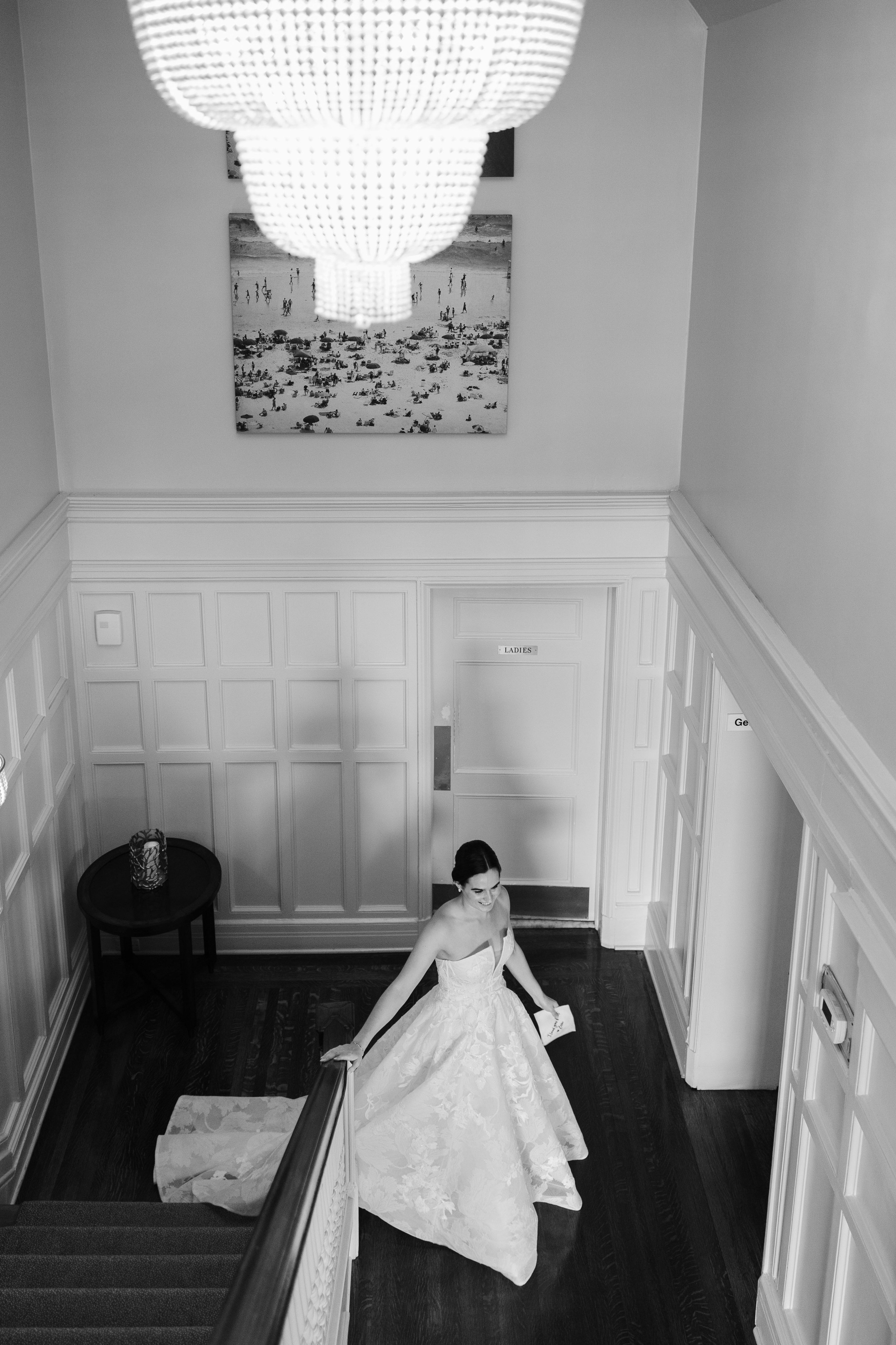 a bride is sitting on the stairs of her home