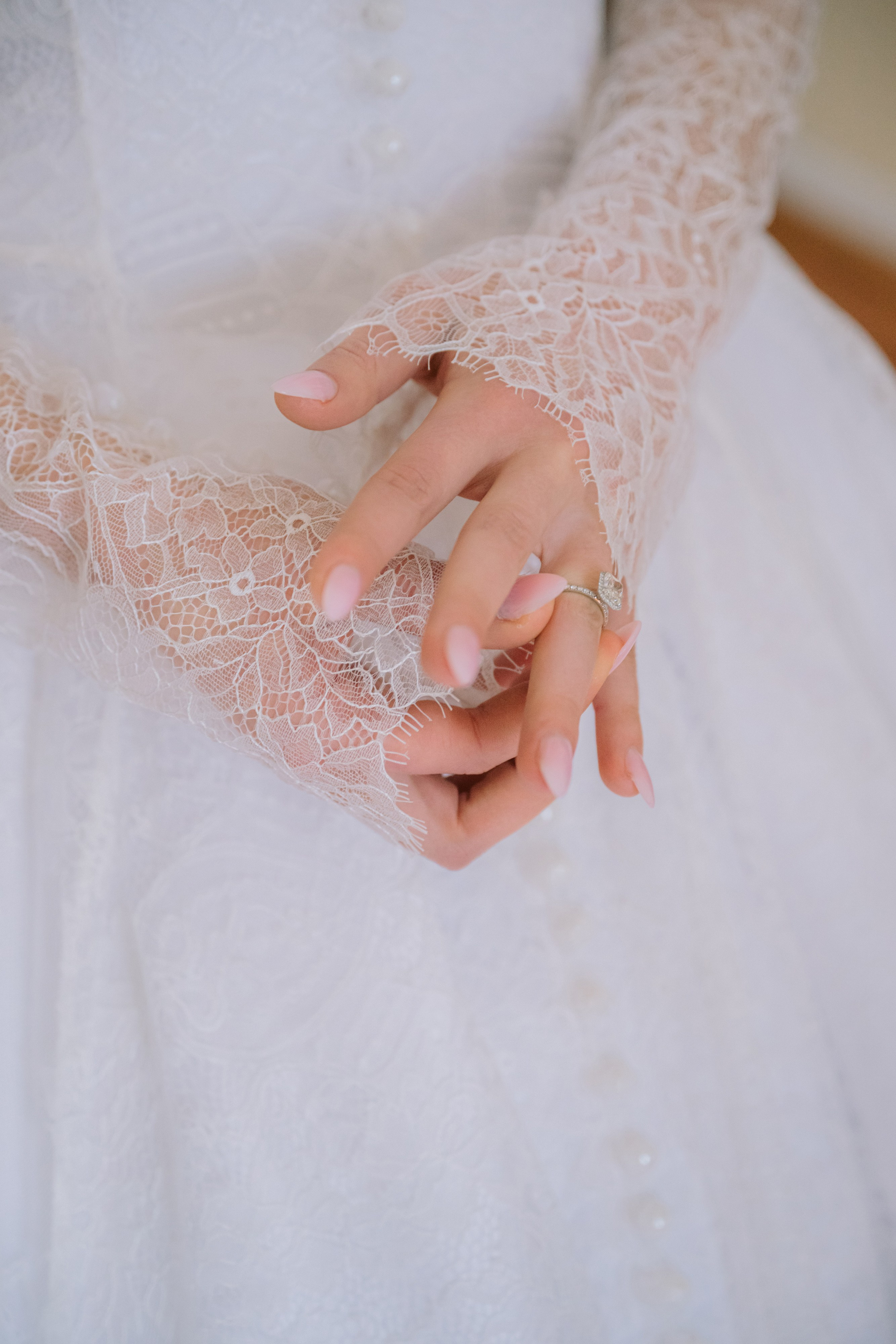 a woman in a wedding dress holding a ring