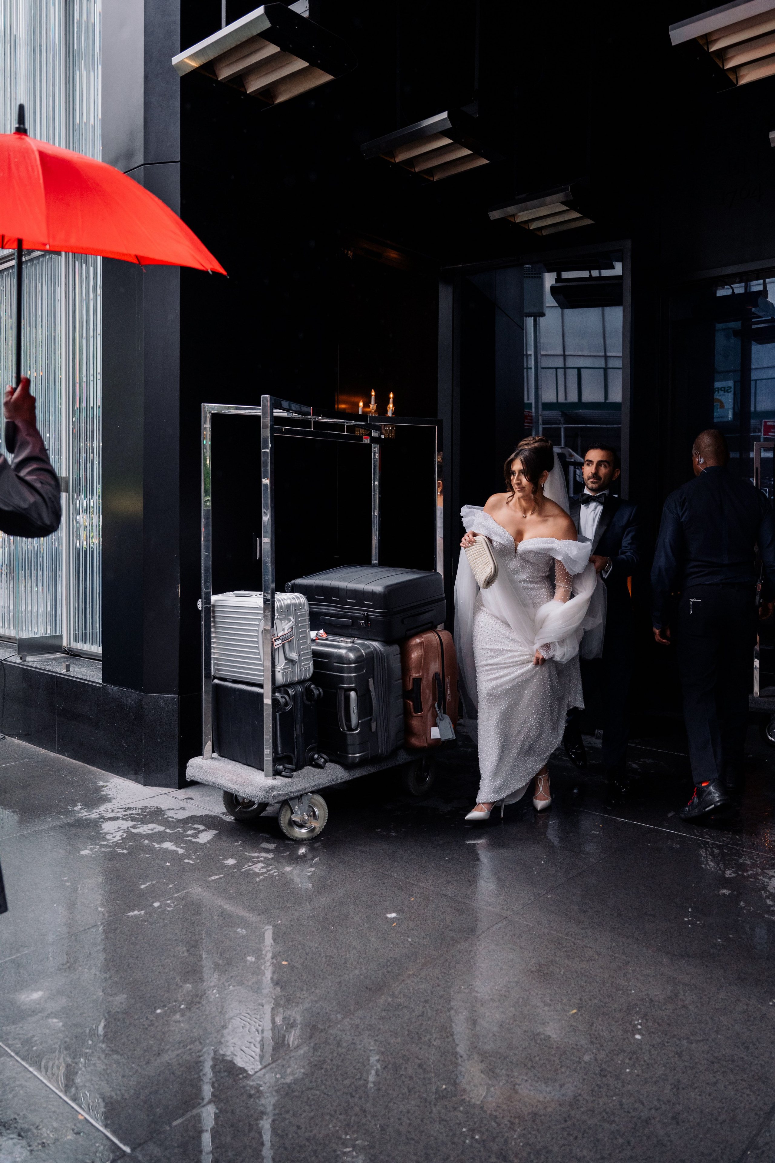 a man and woman walking in the rain