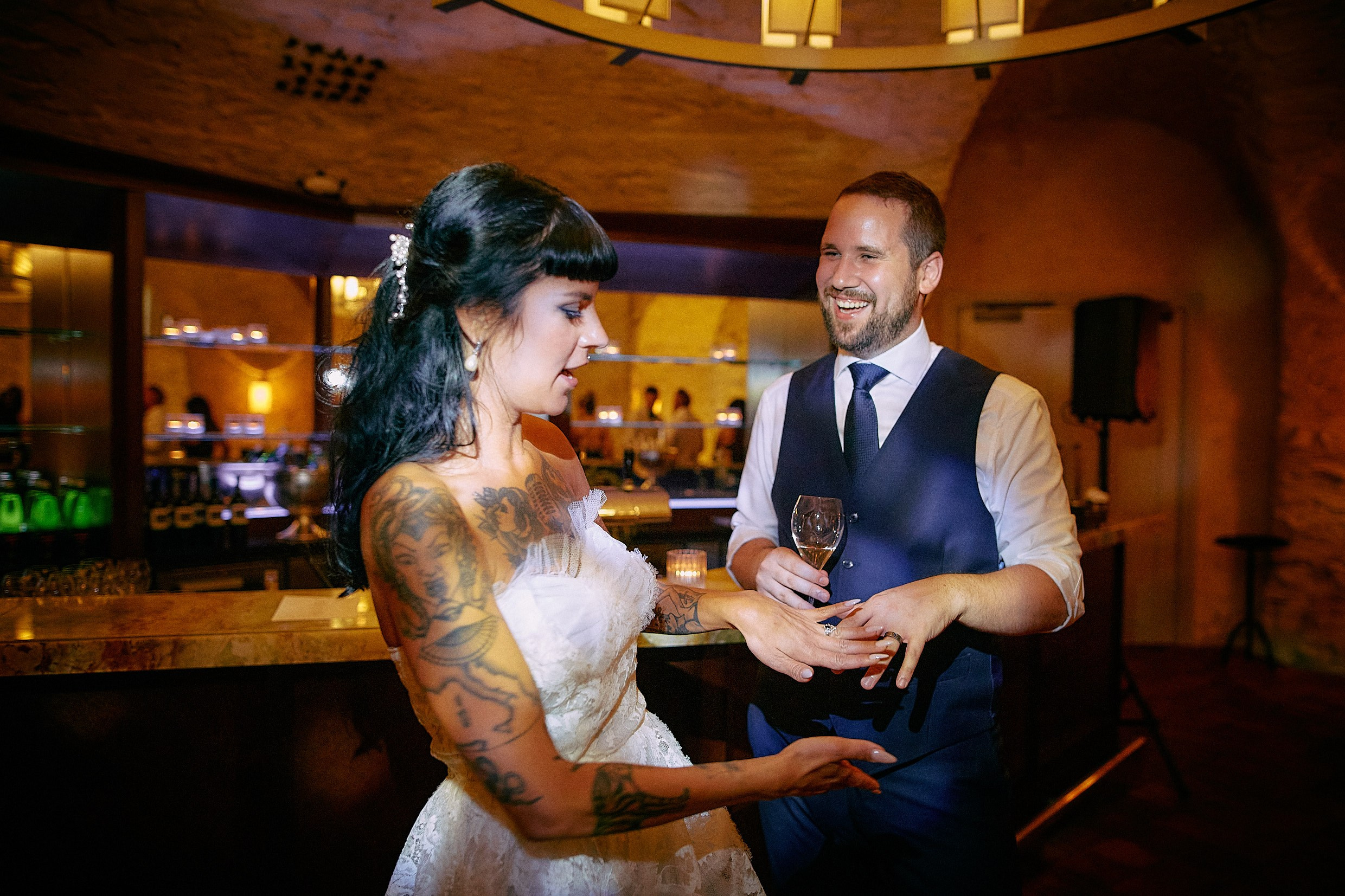 Courtney and Dean laughing while showcasing wedding rings.