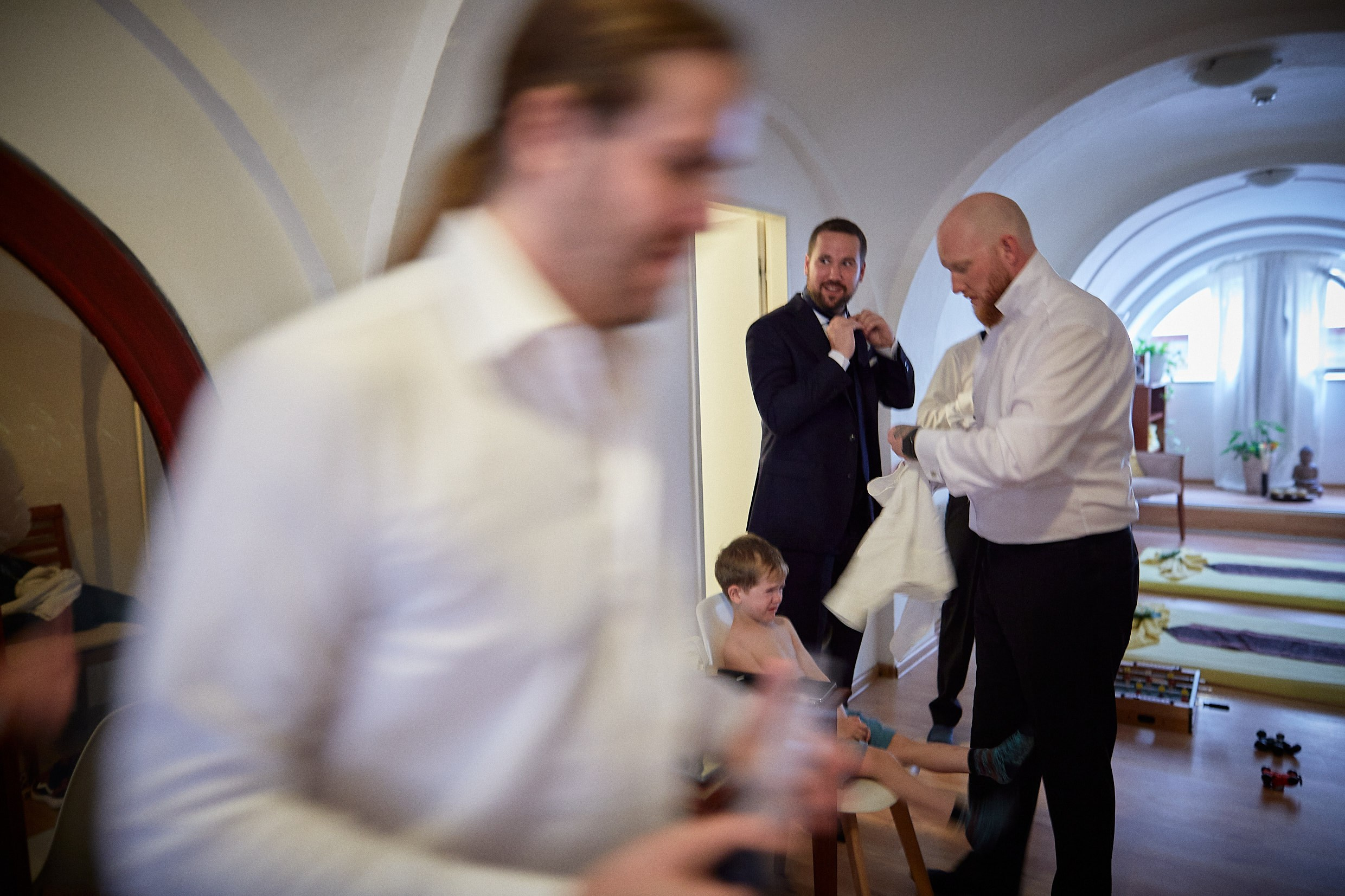 Groom and groomsmen rushing last-minute suit tweaks Prague.