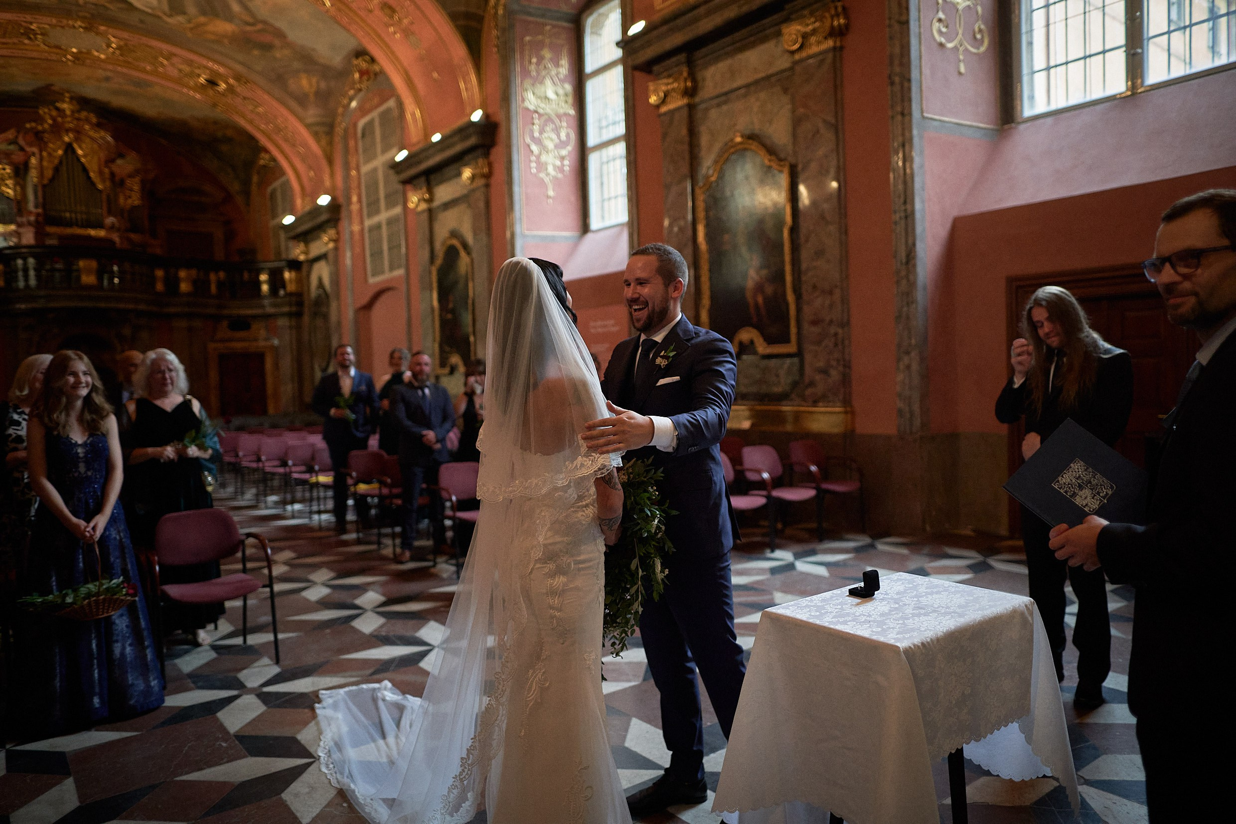 Bride taking groom's hands at start of Klementinum vows.