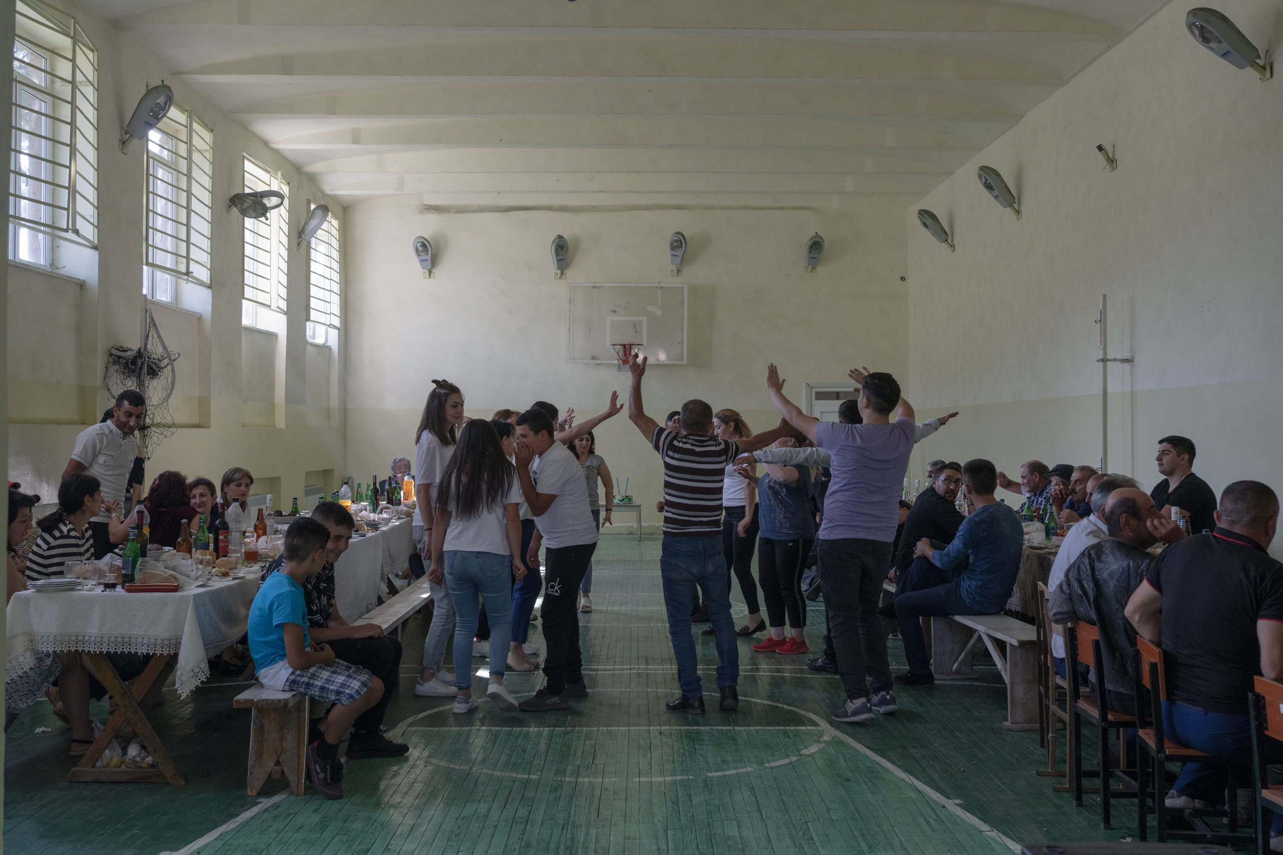 Locals of the border village of Ttujur are celebrating their neighbor's return from the army. Military service in Armenia is mandatory for male citizens aged 18 to 27. Families and neighbors gather for a meal and send off the young men leaving for a two-year service. When they return, they gather again. The celebration after the 2020 Nagorno-Karabakh was especially important to all families who had children serving in the army and fighting the war.