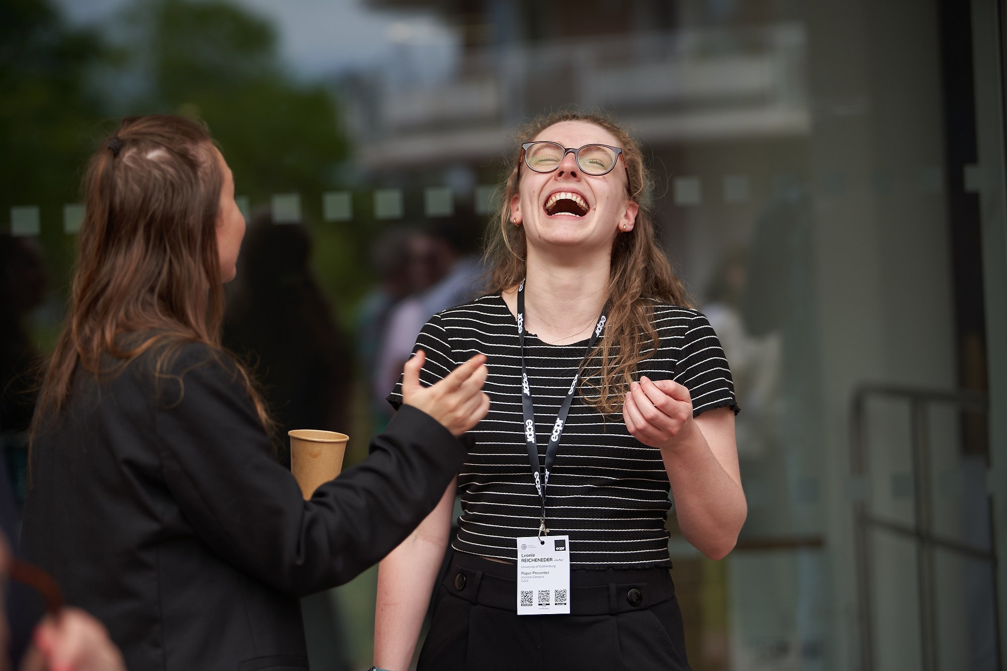 A woman laughs out loud during a break at the ECPR event at Charles University.