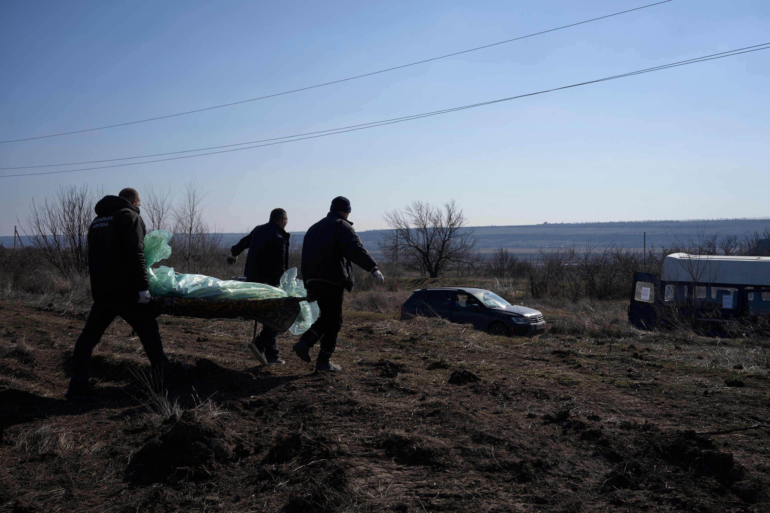 Workers of Voznesensk funeral agency carrying dead body of Russian soldier to bring it to the morgue.