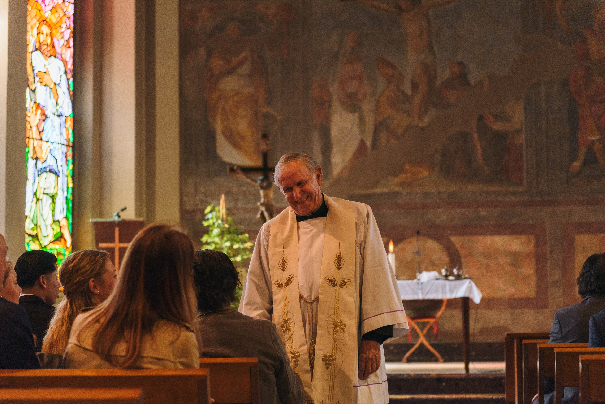 Photographer priest in church in Milan. Baptism Photographer