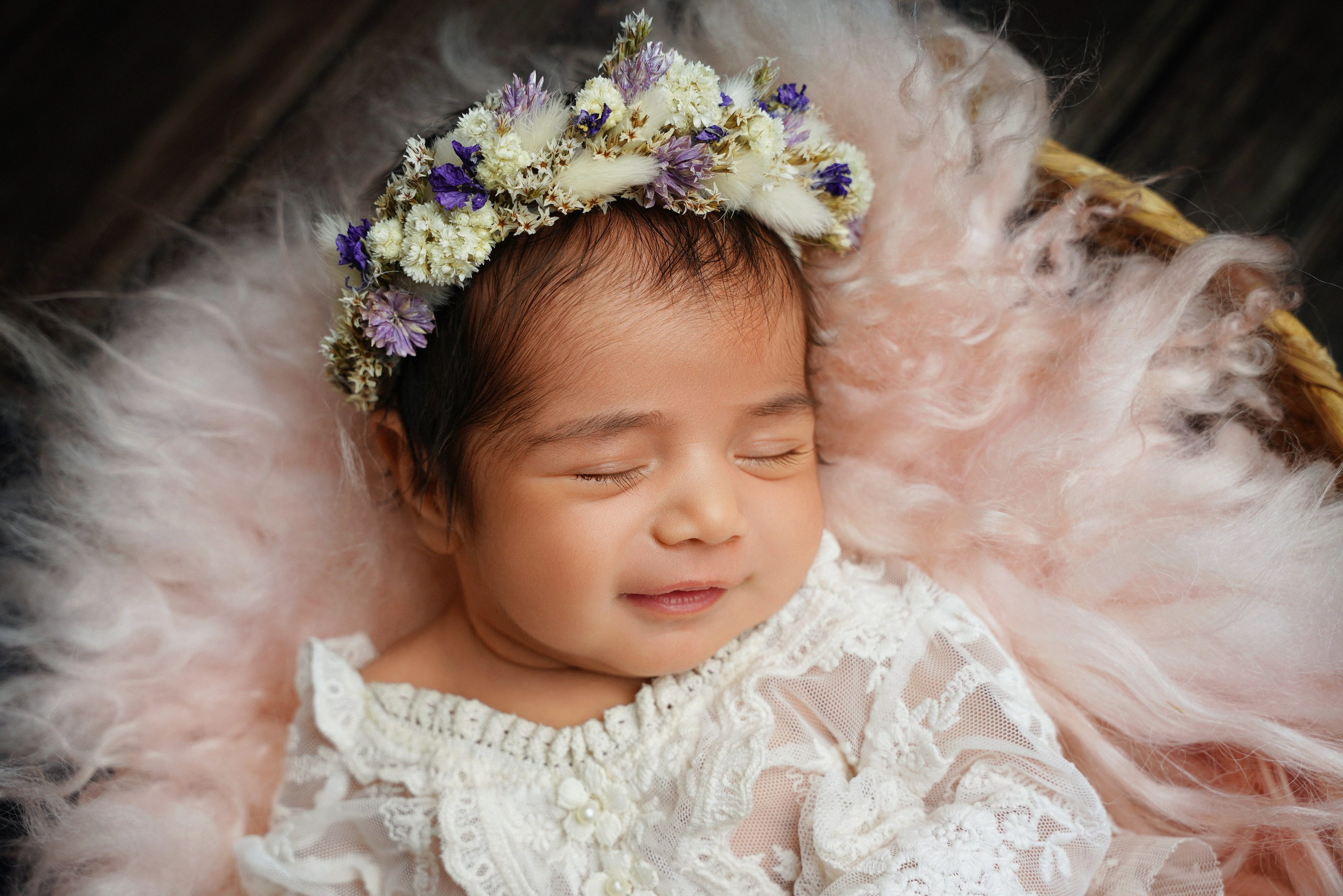Neugeborenes Baby schläft friedlich in einem rustikalen Holzkorb – Newborn Fotografie Augsburg