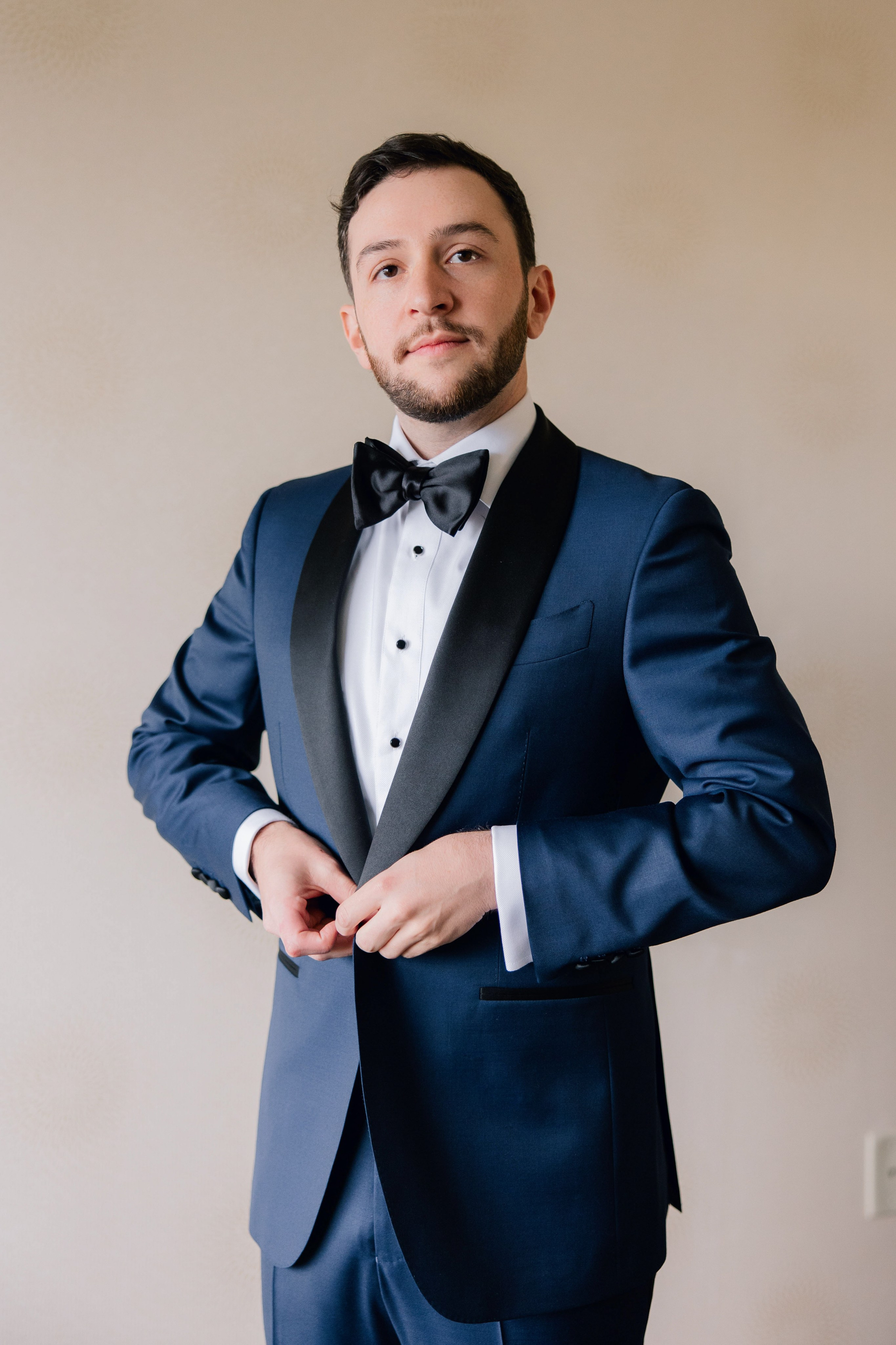 a man in a suit and bow tie
