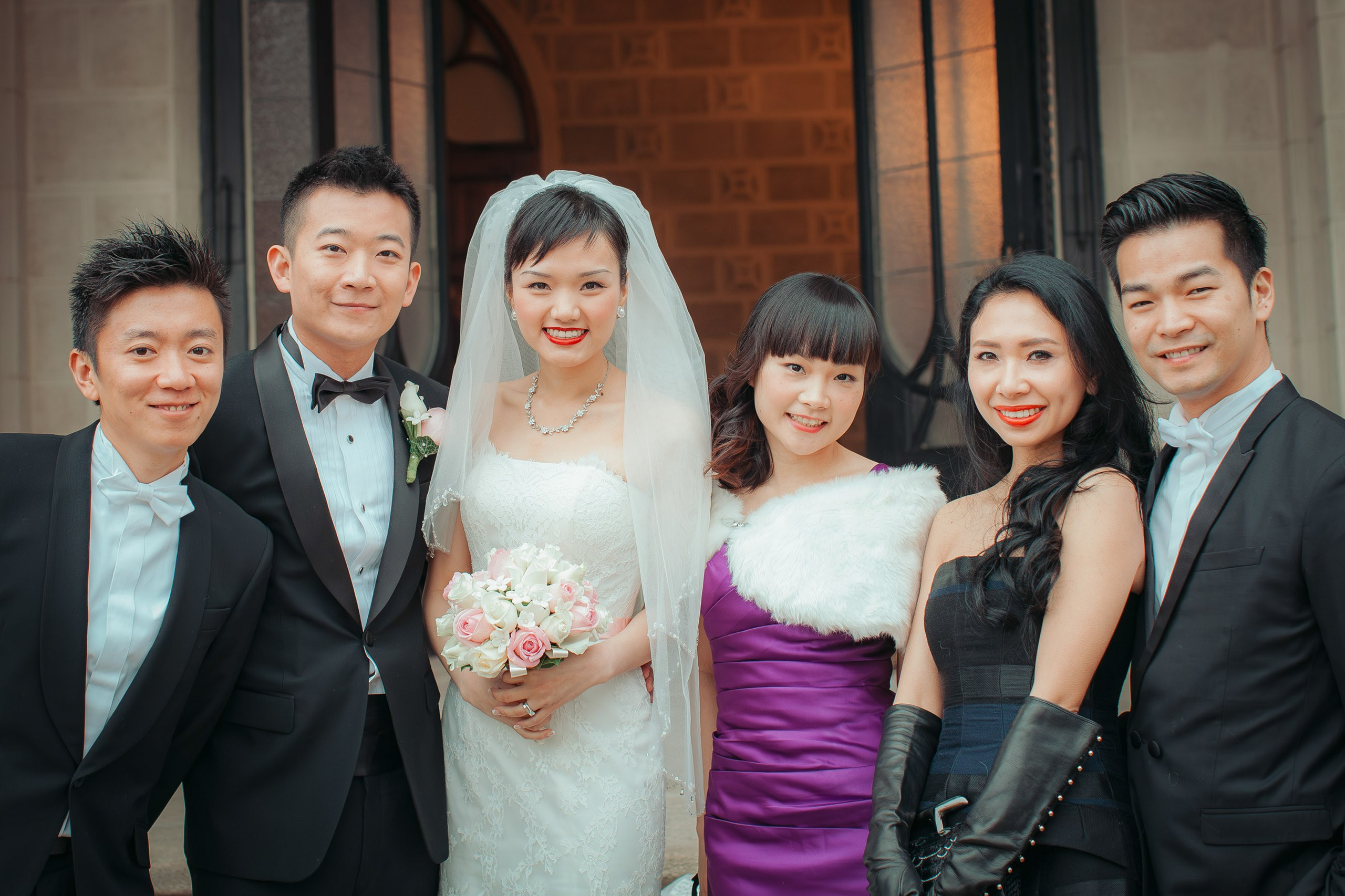 The newlyweds and their friends from Hong Kong pose for a group photo on the grounds of Castle Hluboka during their intimate destination wedding.
