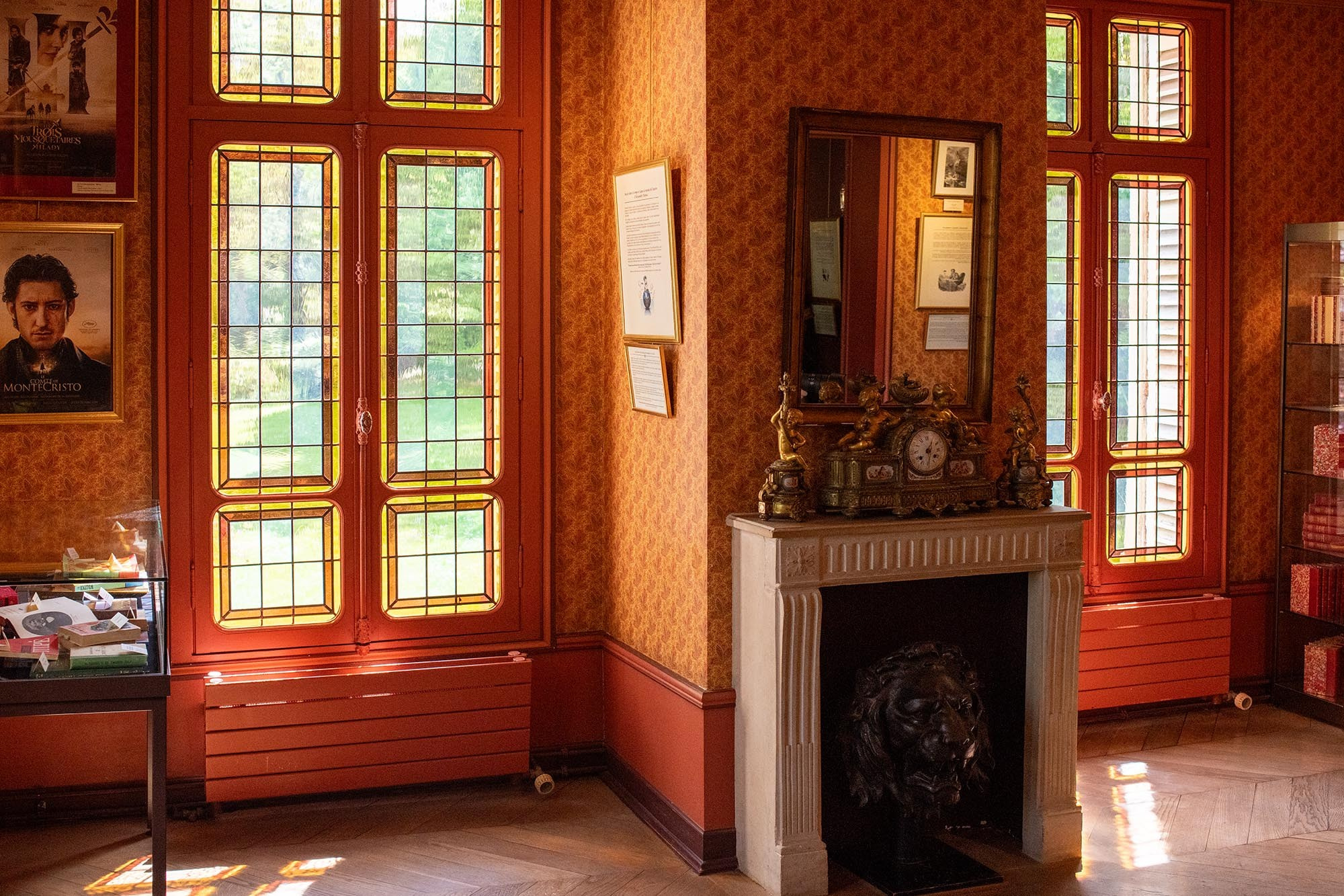 Historic interior with stained-glass windows and marble fireplace at the Château de Monte-Cristo museum dedicated to Alexandre Dumas