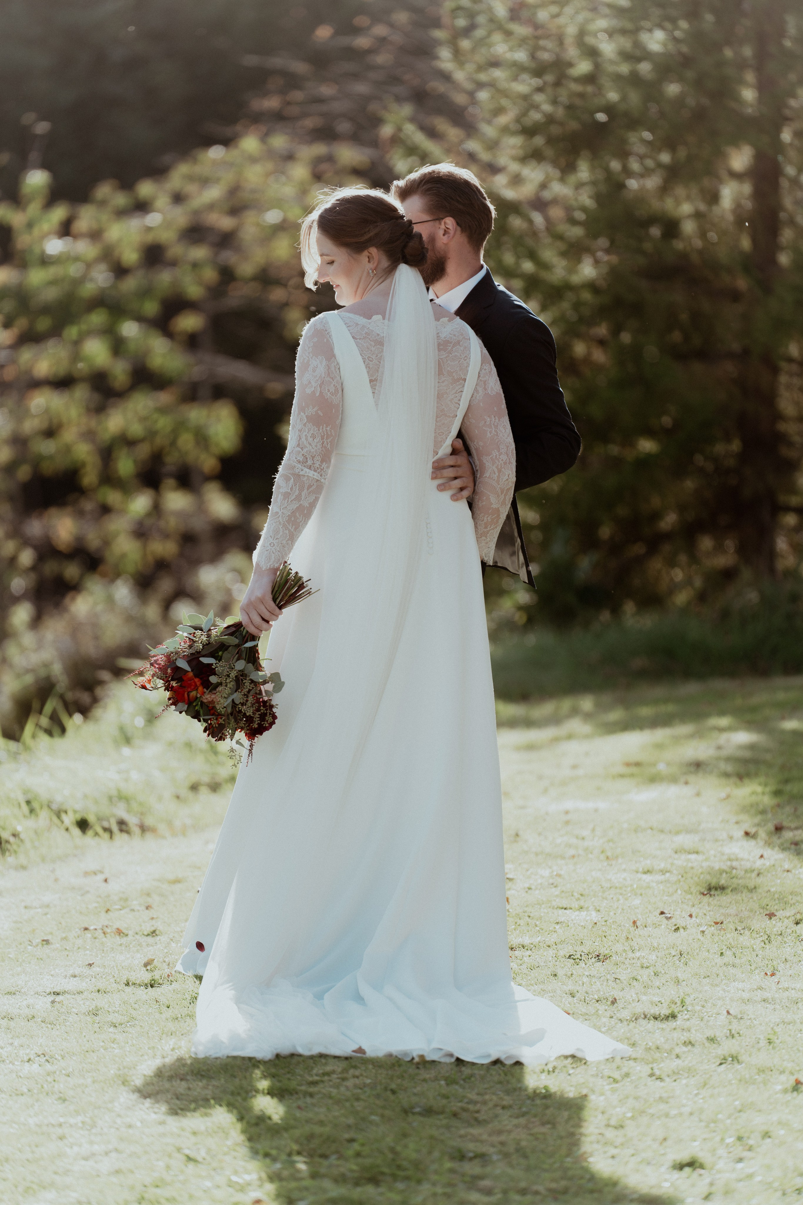 Det vakre brudeparet står ved siden av hverandre og ser på hverandre en sensommerdag