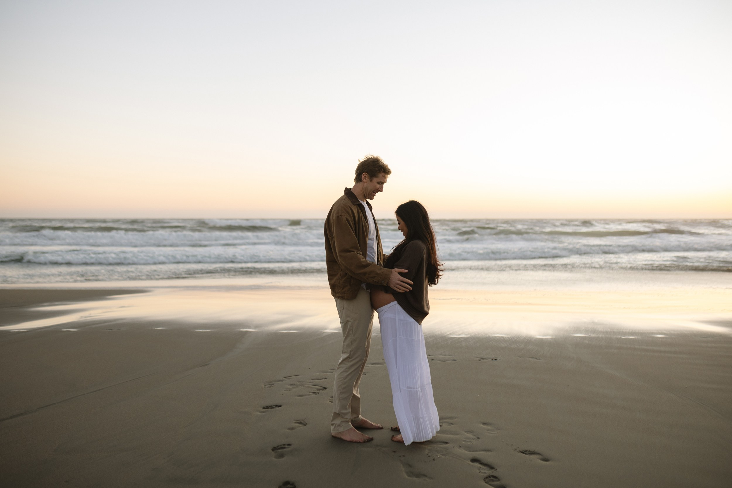 Natural maternity portraits at Ocean Beach during blue hour