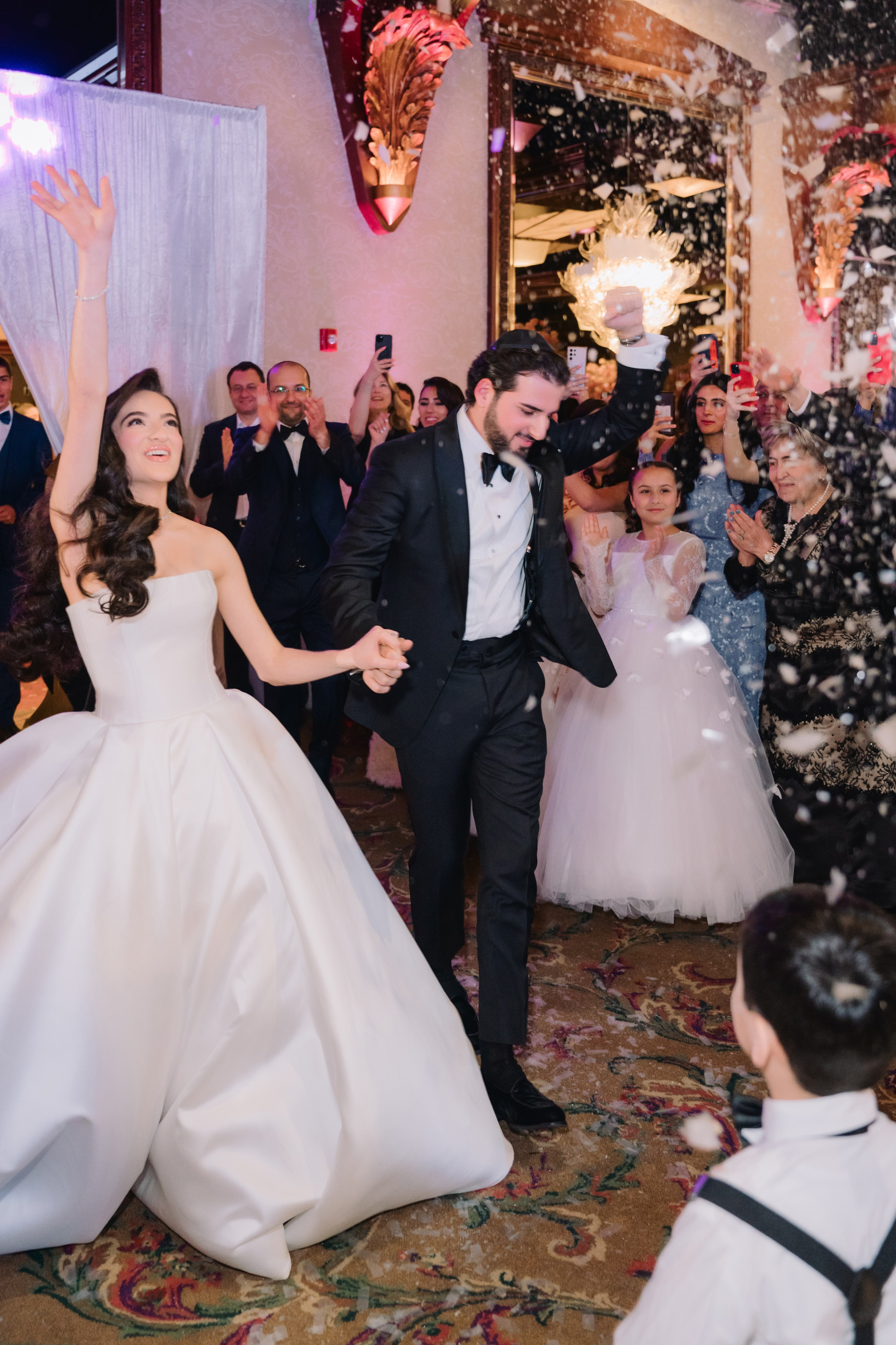 a bride and groom are showereded by confetti