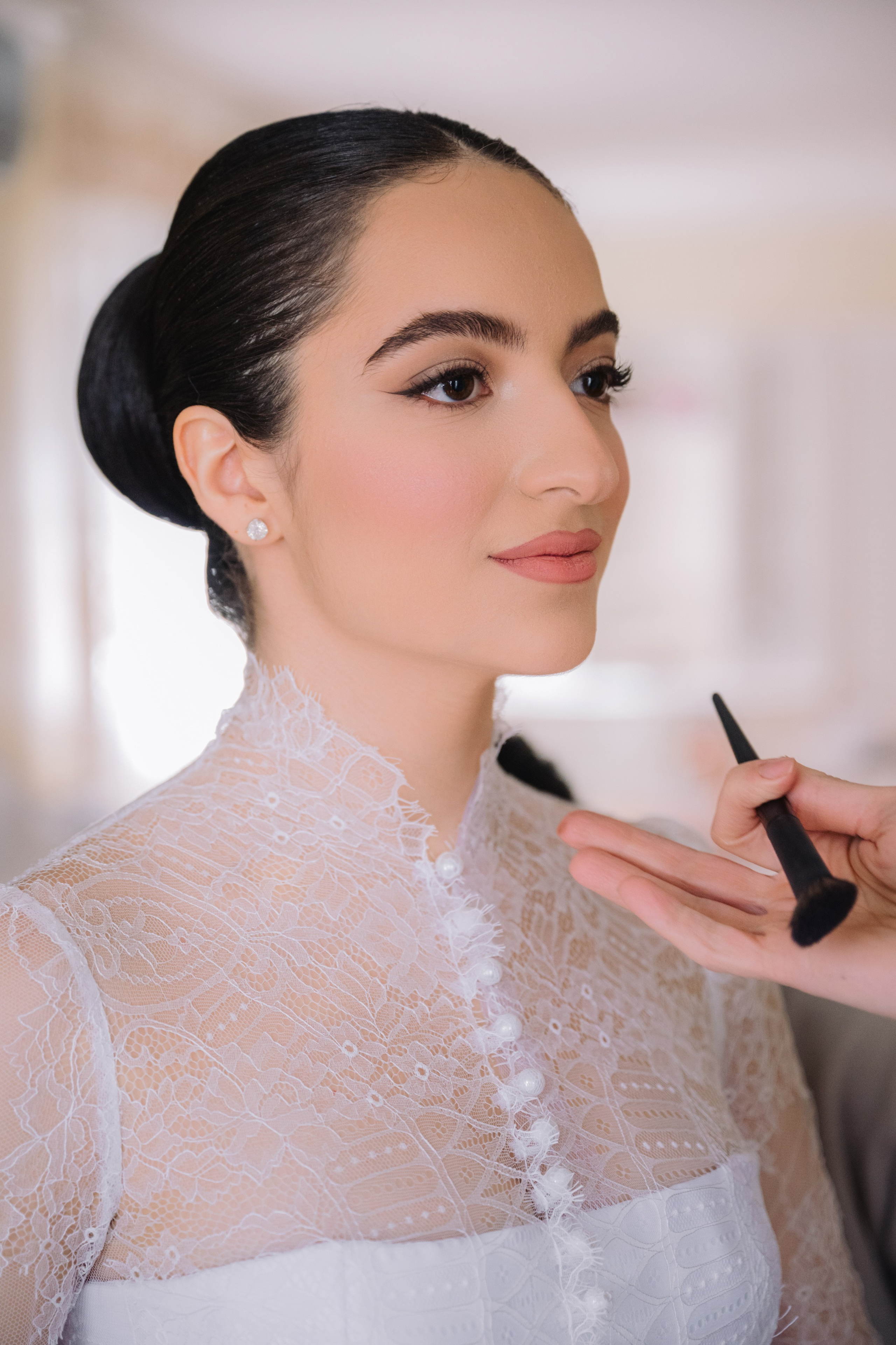 a woman is putting her makeup on