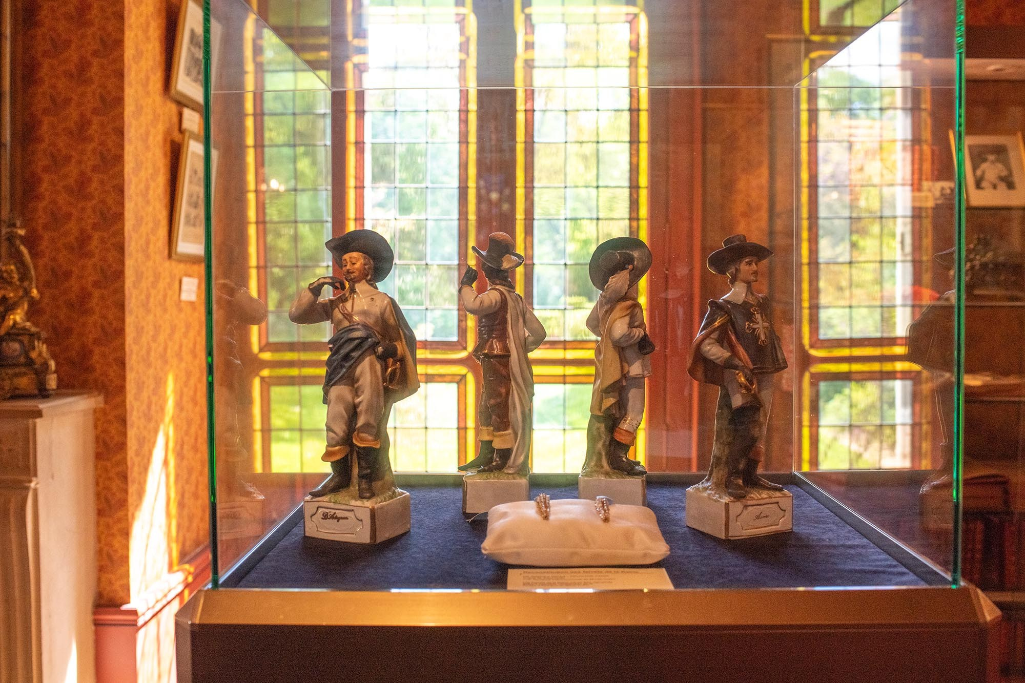 Display case with Four Musketeers figurines at the Château de Monte-Cristo museum dedicated to Alexandre Dumas