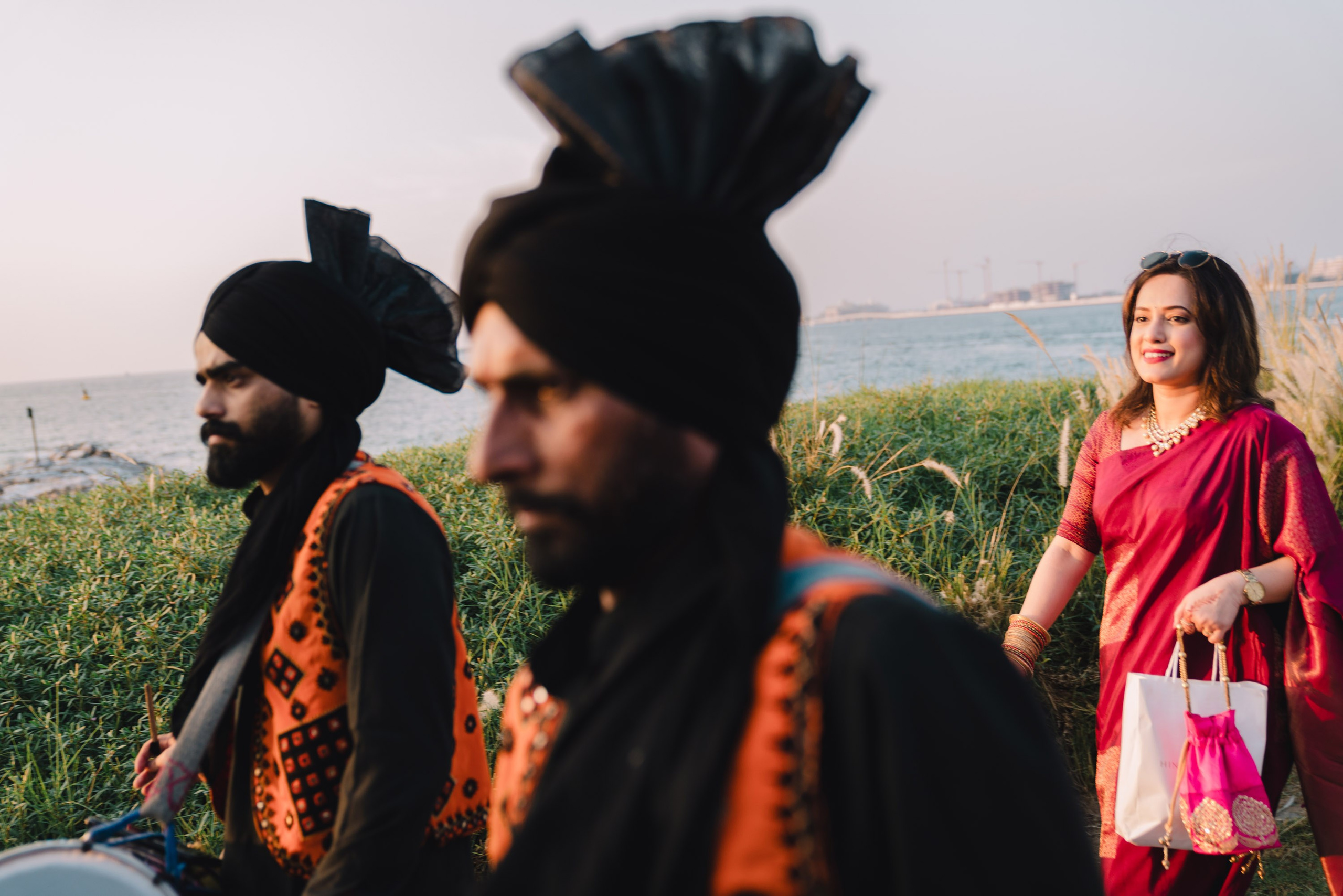 Two drummers with dramatic facial expressions and the lady on the background