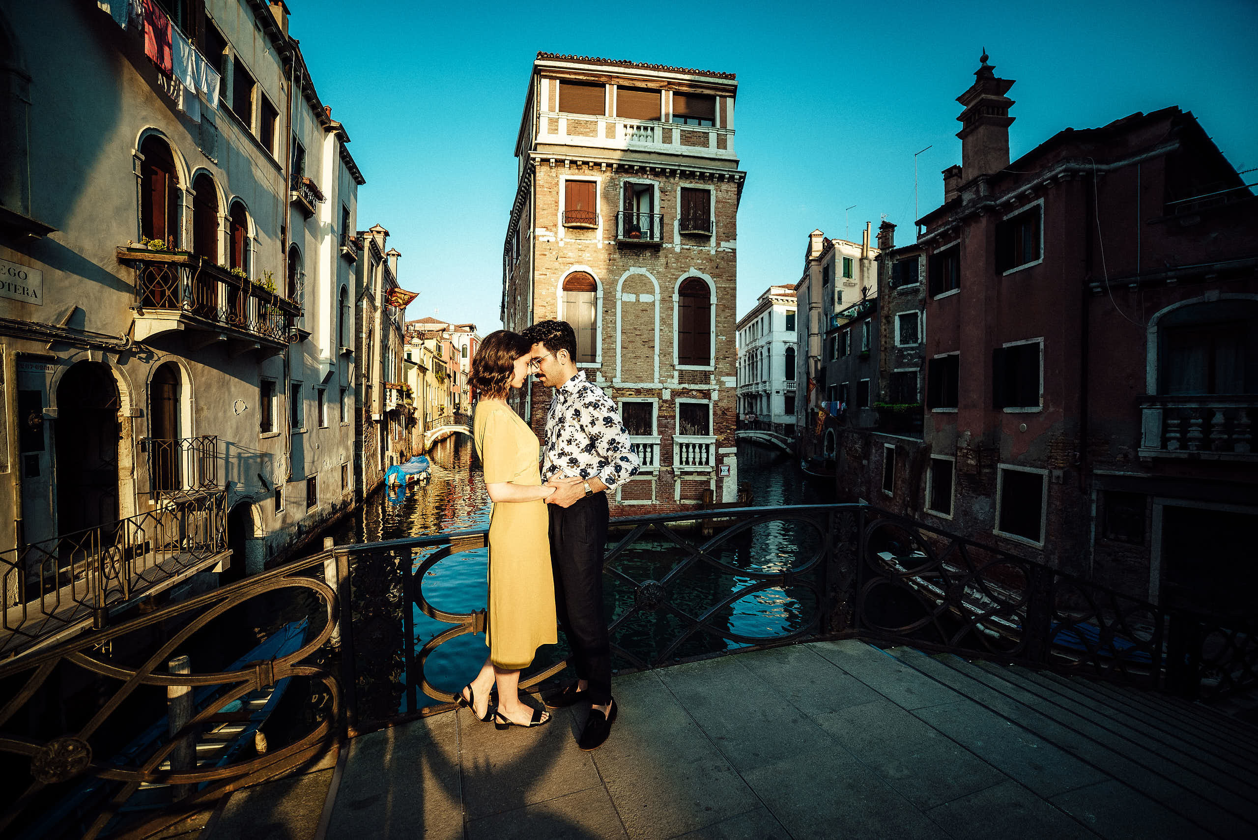 panorama shot of couple kissing on the bridge