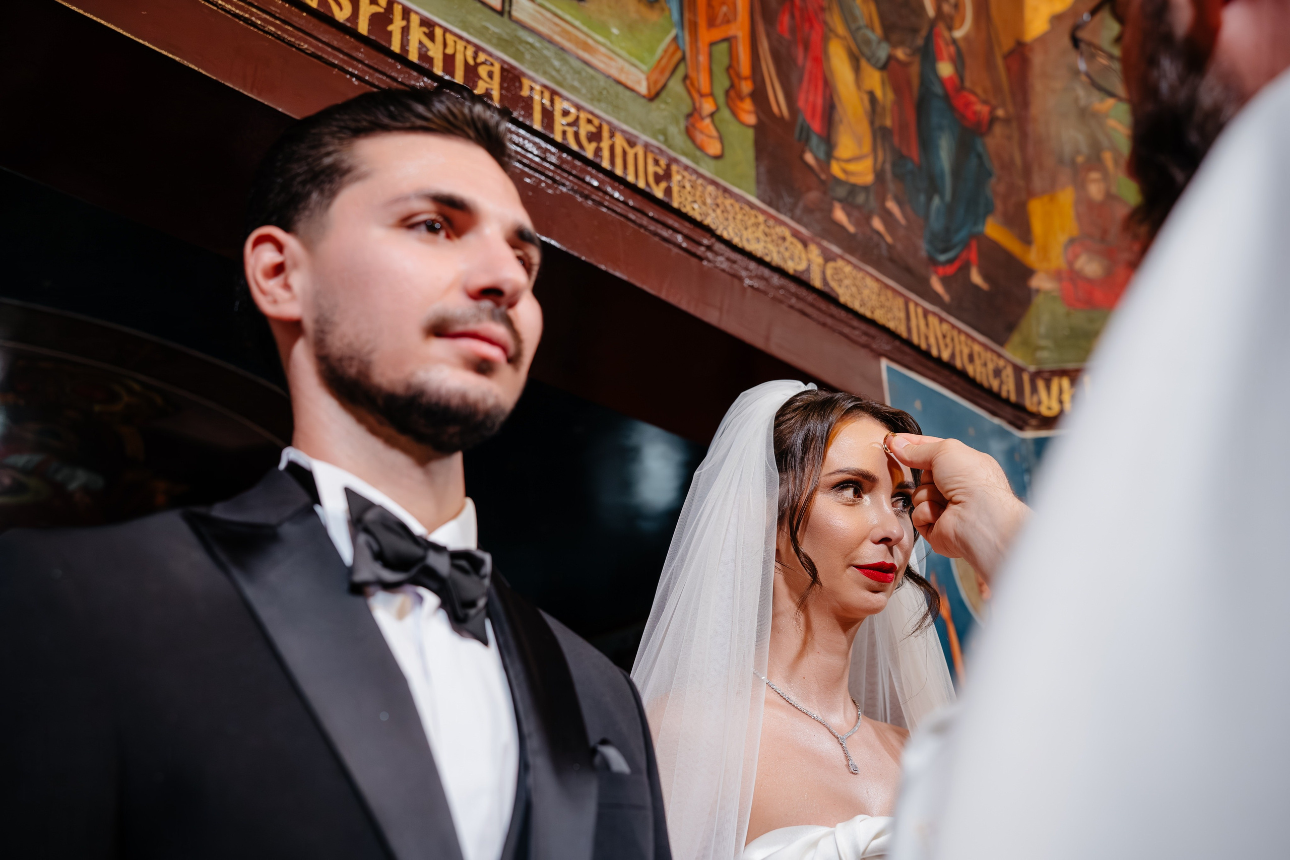 Detaliu cu preotul binecuvântând mirii, nuntă religioasă județul Bacău.