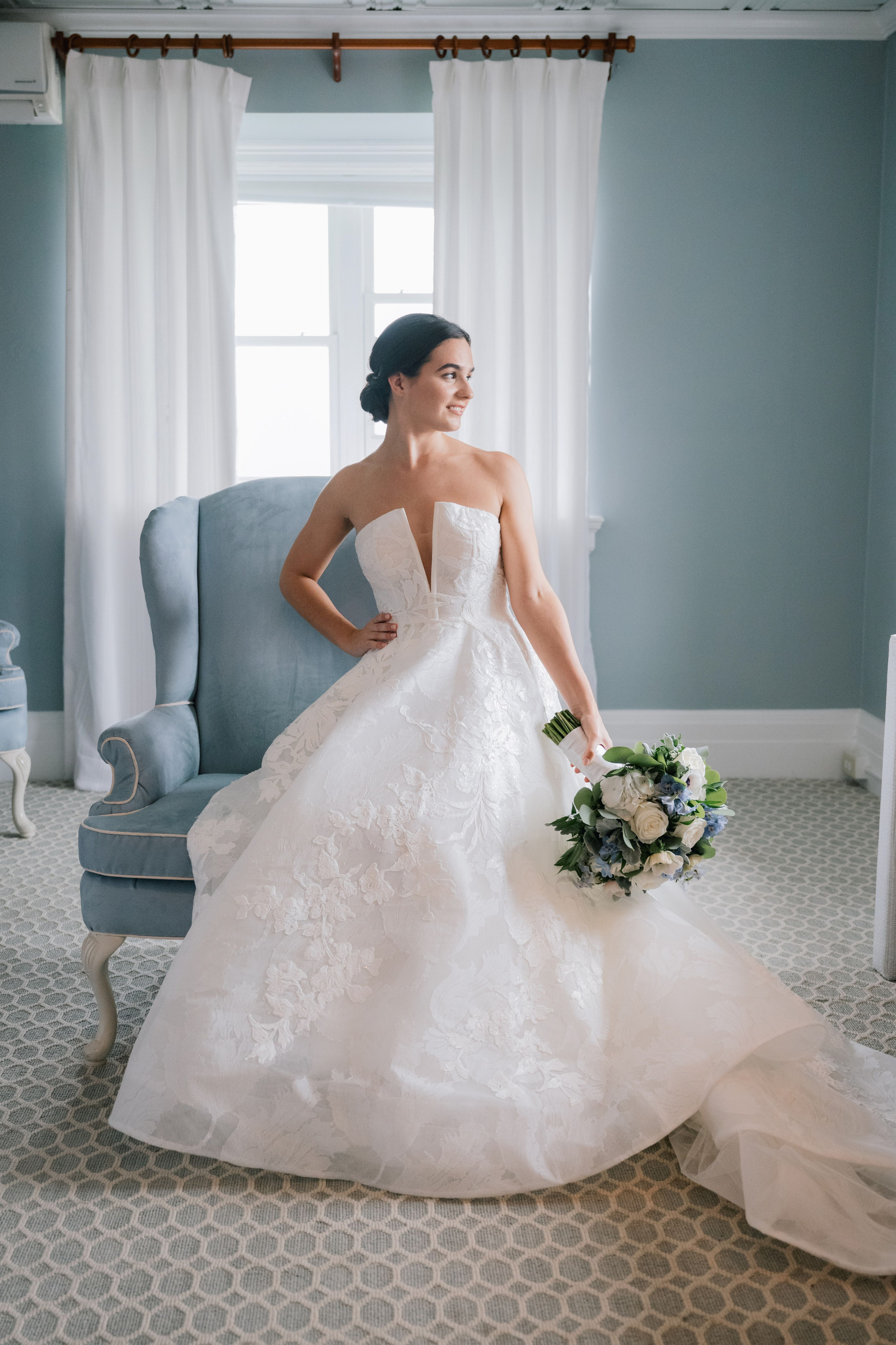 a bride in her wedding dress sitting on a chair