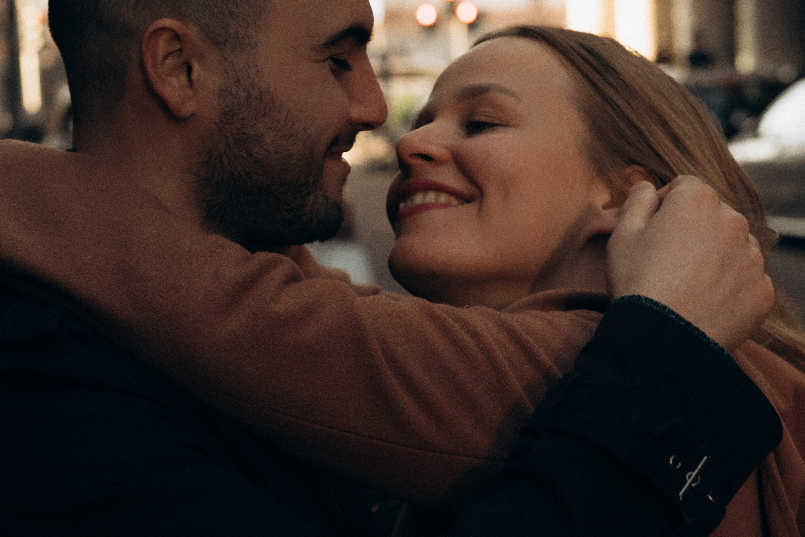 Close-up of a smiling couple leaning into each other for a kiss. Milan love story photographer. Photographer for couple in Milan