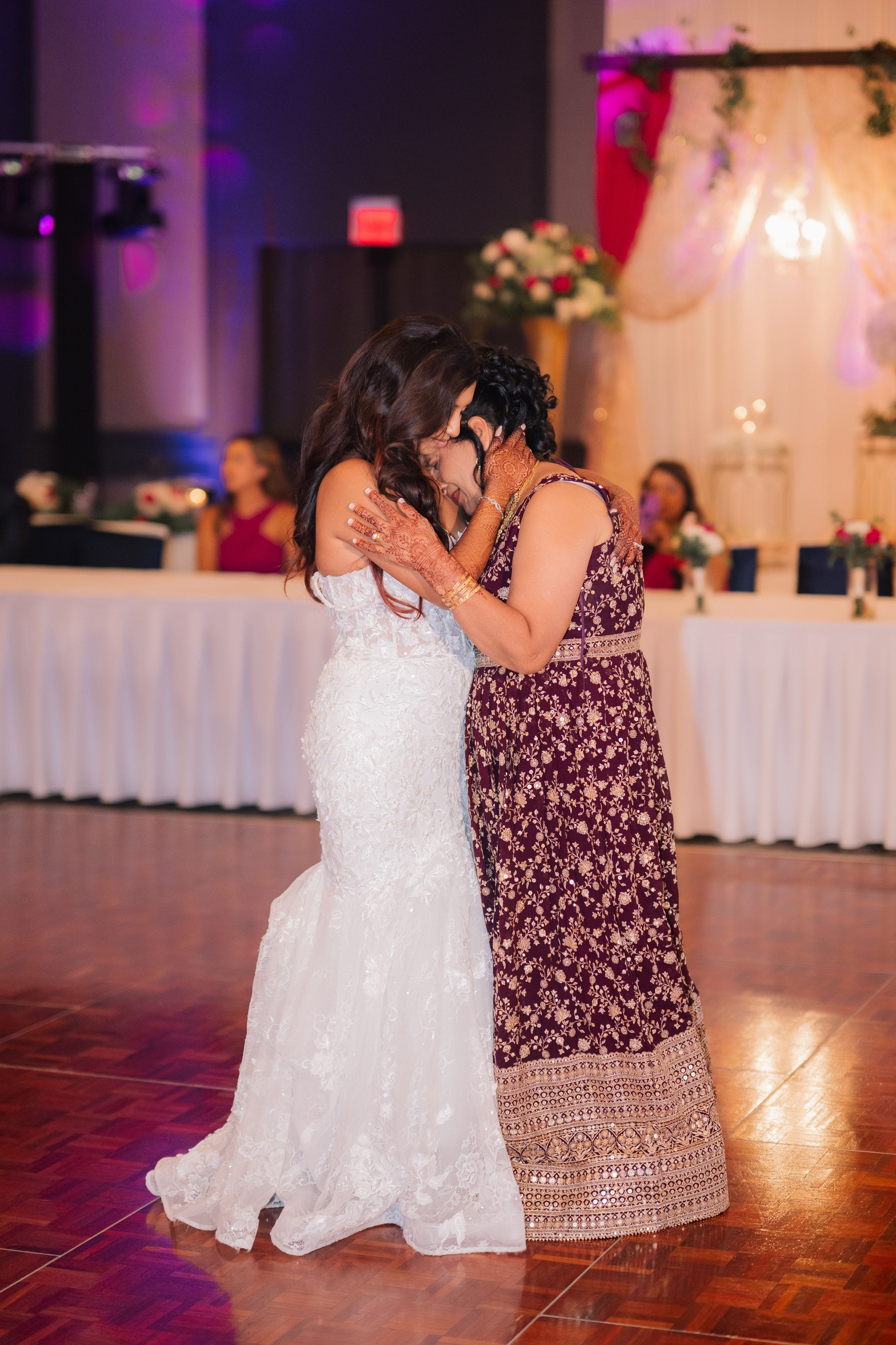 a bride and her mother sharing a dance