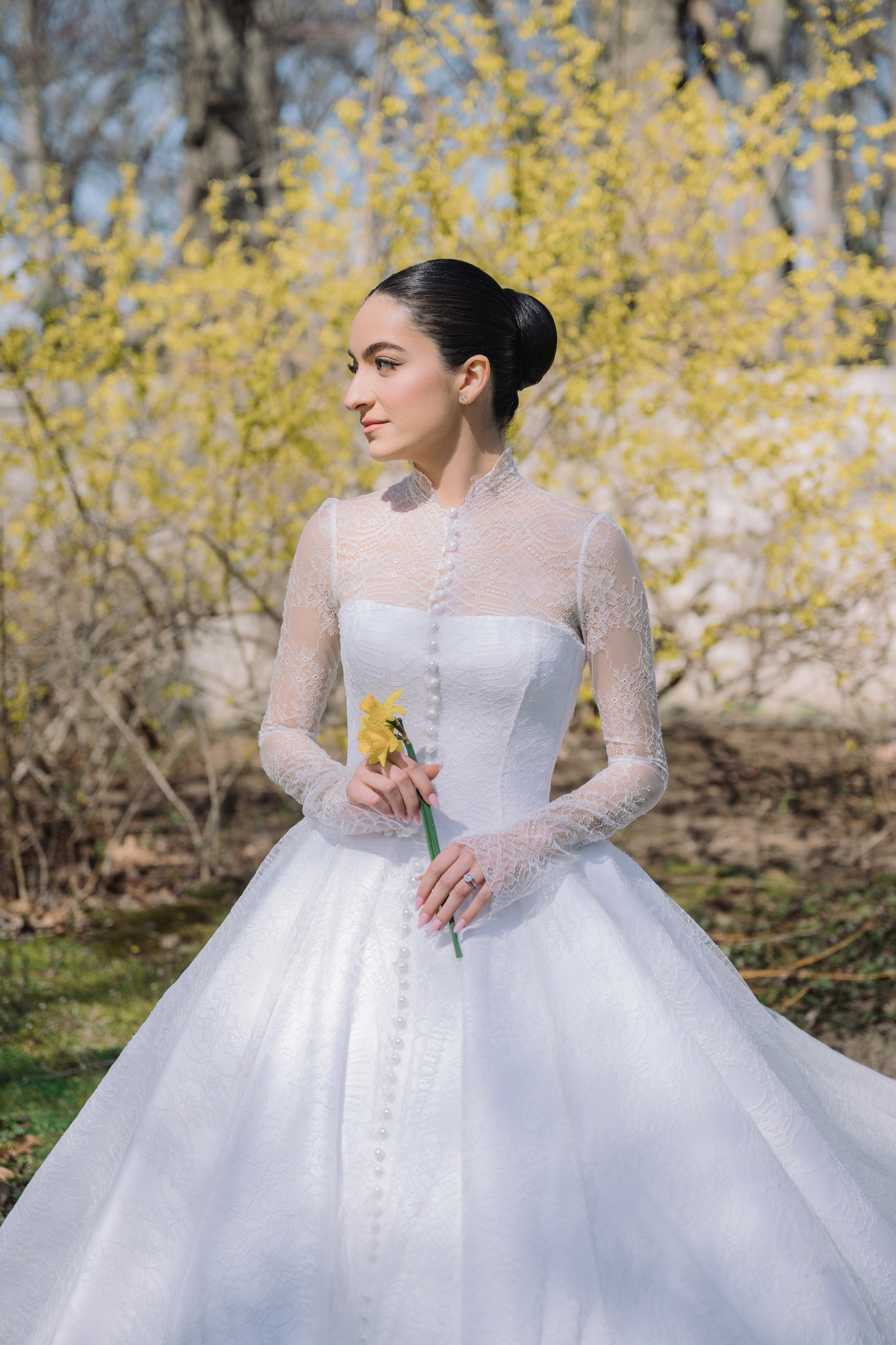 a woman in a white wedding dress standing in front of a tree