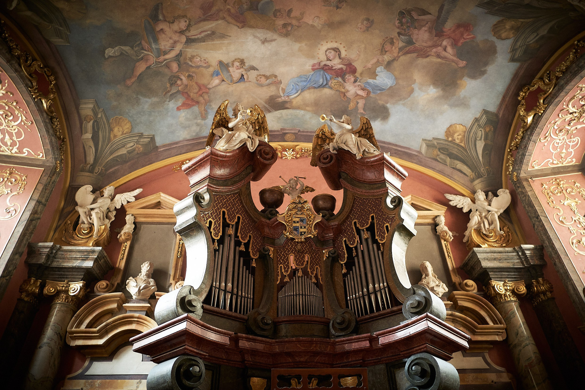 Opulent interior of Klementinum Mirror Chapel prepared for intimate wedding.