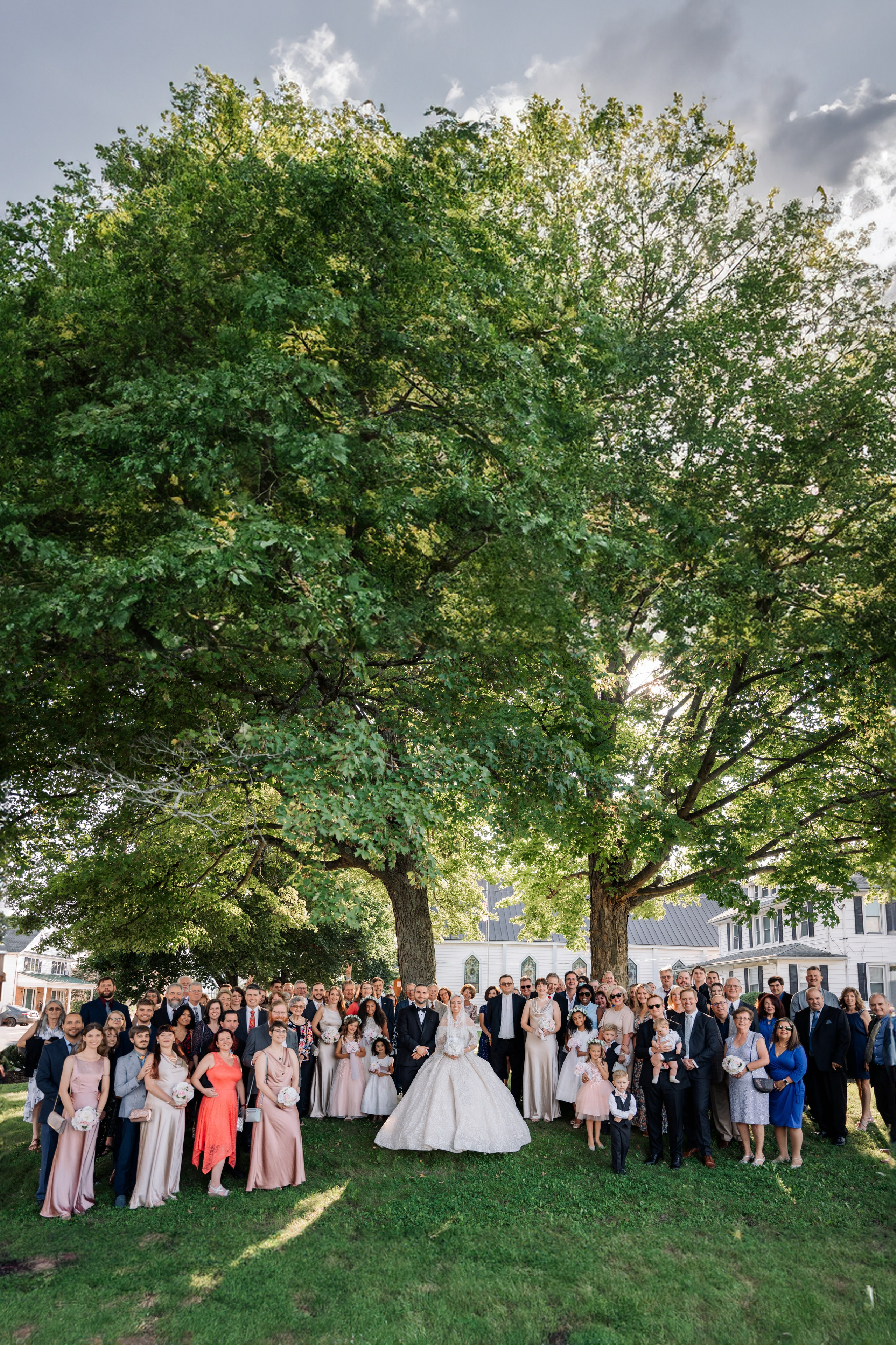 a group of people standing under a tree