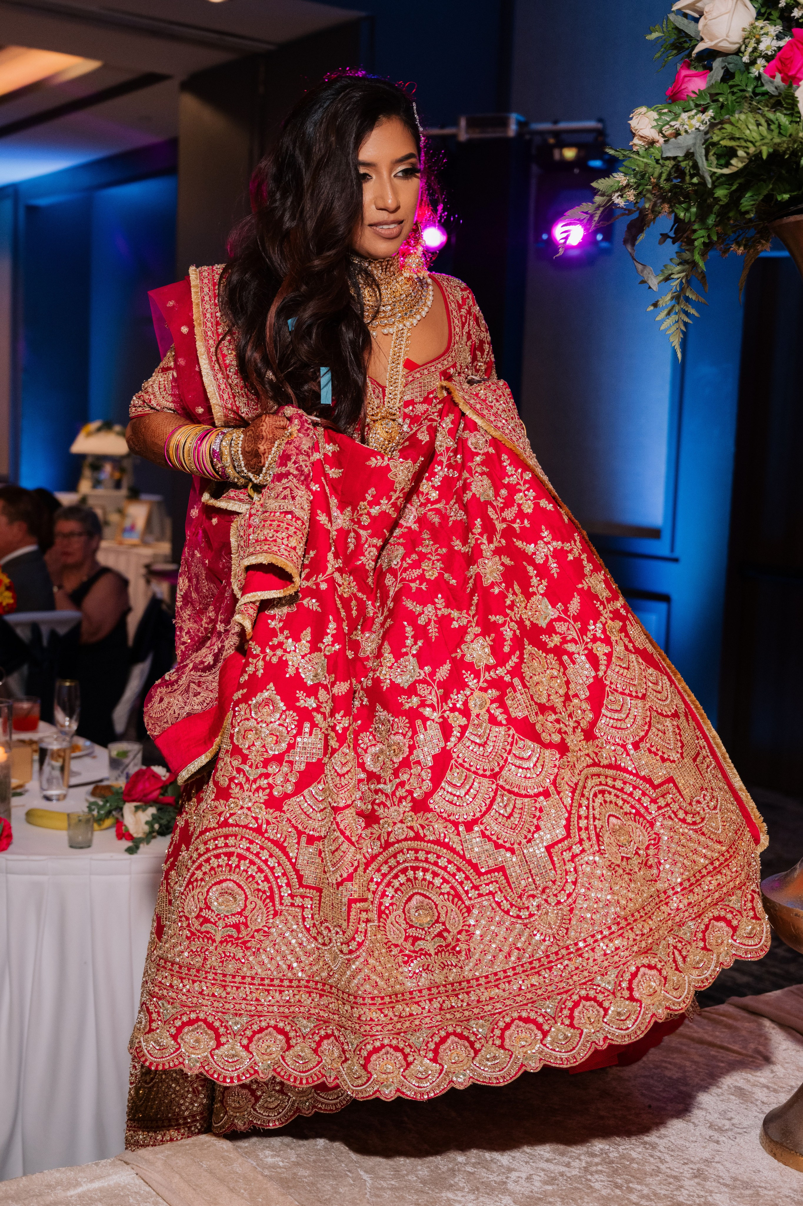 a woman in a red and gold dress dancing