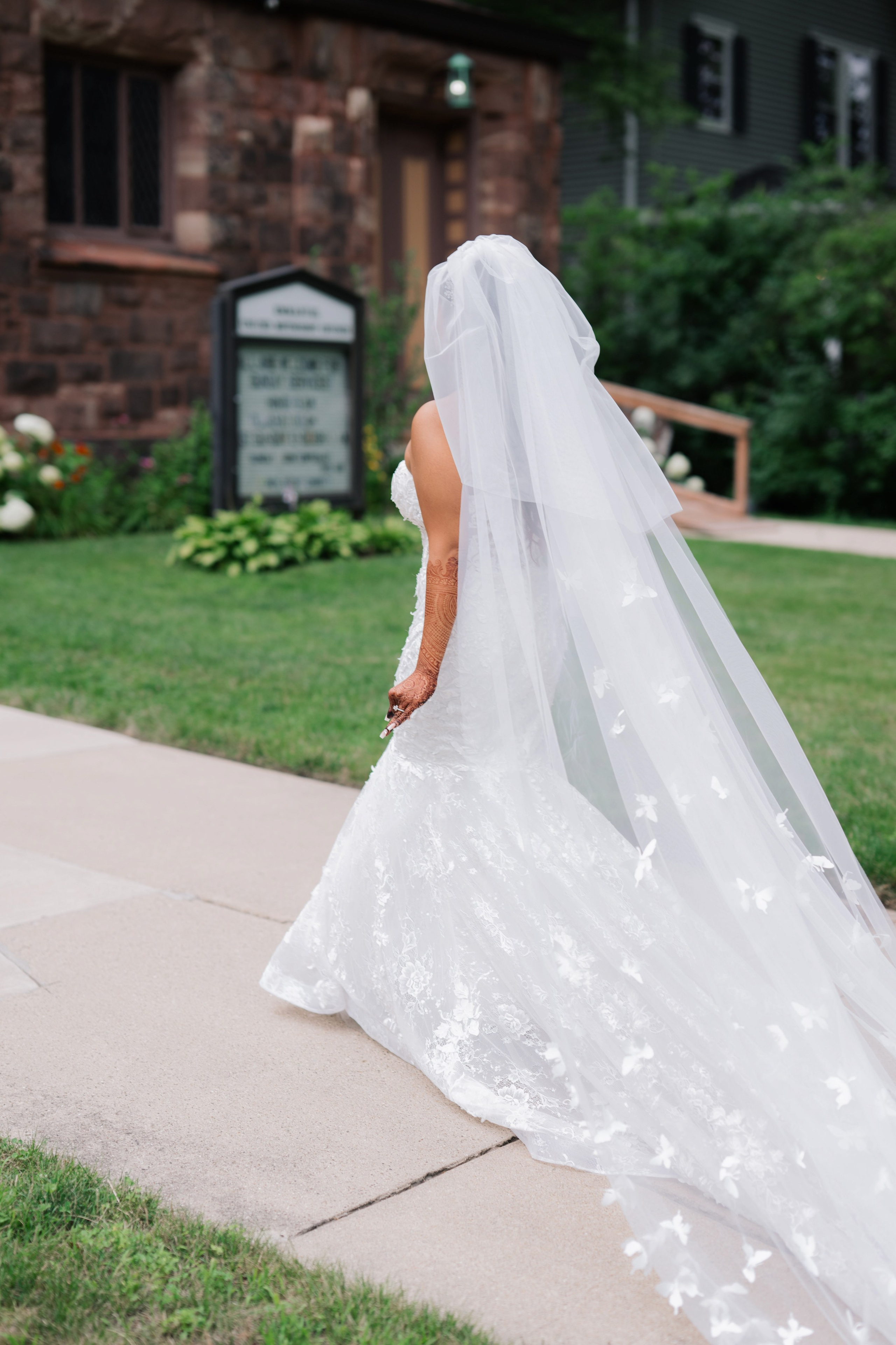 a bride walking down the sidewalk in her wedding dress